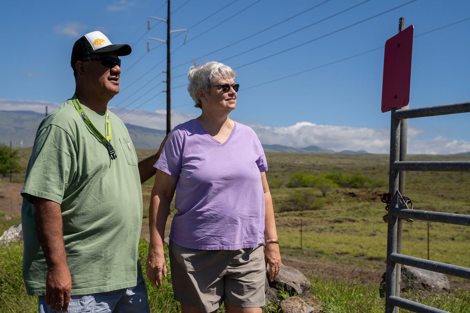 Dana Aina, a firewise community support specialist for the Hawaii Wildfire Management Organization, left, poses for a portrait with his wife, Shelly, an NFPA-trained wildfire home assessor, Tuesday, Feb. 25, 2025, in Waikoloa Village, Hawaii. (AP Photo/Mengshin Lin)