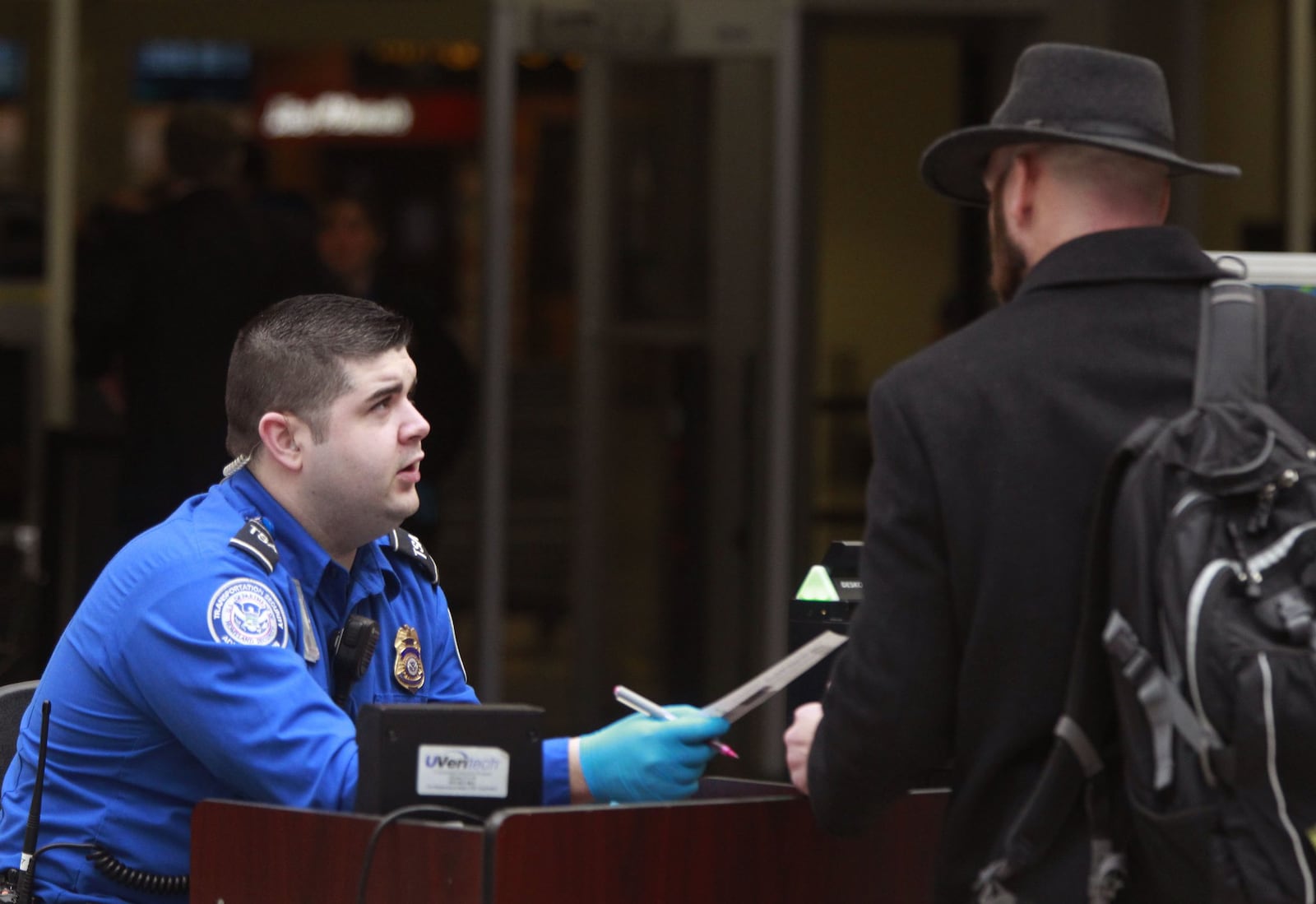 A federal TSA worker at the Dayton International Airport checks passengers at TSA Precheck. Data from the U.S. Office of Personnel Management show that Ohio was home to slightly more than 56,000 federal civilian employees in September 2024, according to data published in late February. TY GREENLEES / STAFF