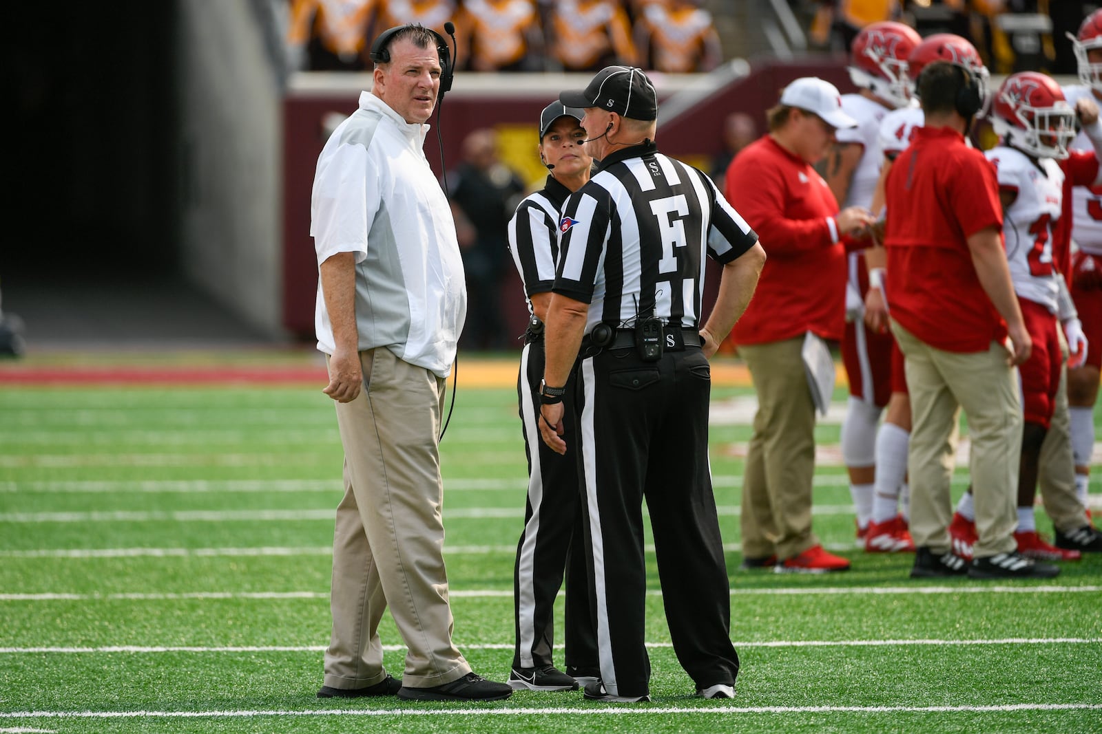 Miami-Ohio head coach Chuck Martin, left, talks with the game officials during a break in the first half of an NCAA college football game against Minnesota Saturday, Sept. 11, 2021, in Minneapolis. Minnesota won 31-26. (AP Photo/Craig Lassig)