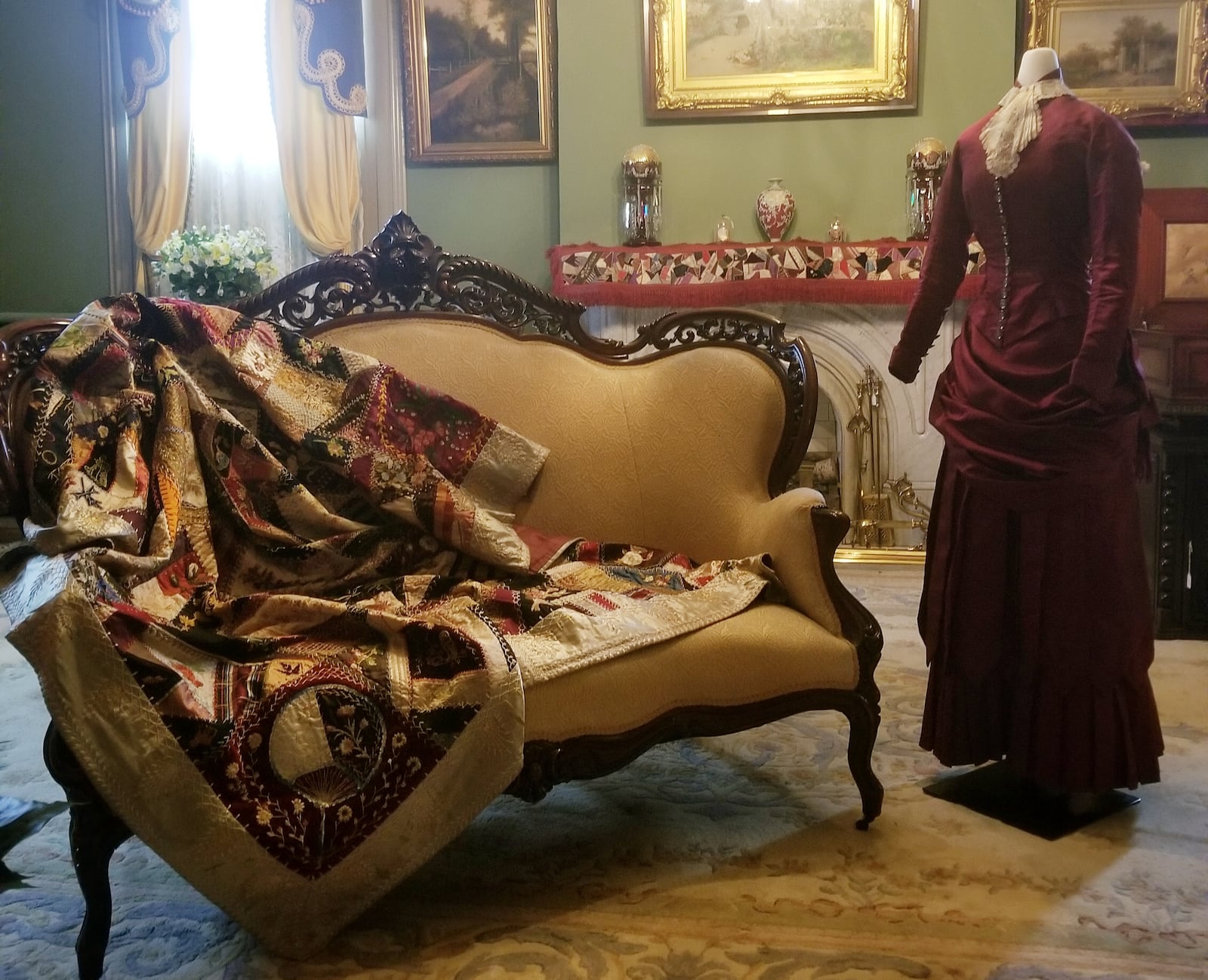 Fancy Crazy Quilt, dated 1883, is in the exhibit with some period fashions that are paired with quilts to show that sources of quilting fabric were textiles manufactured for clothing. The outfit on the mannequin is an 1883 high school graduation dress. CONTRIBUTED