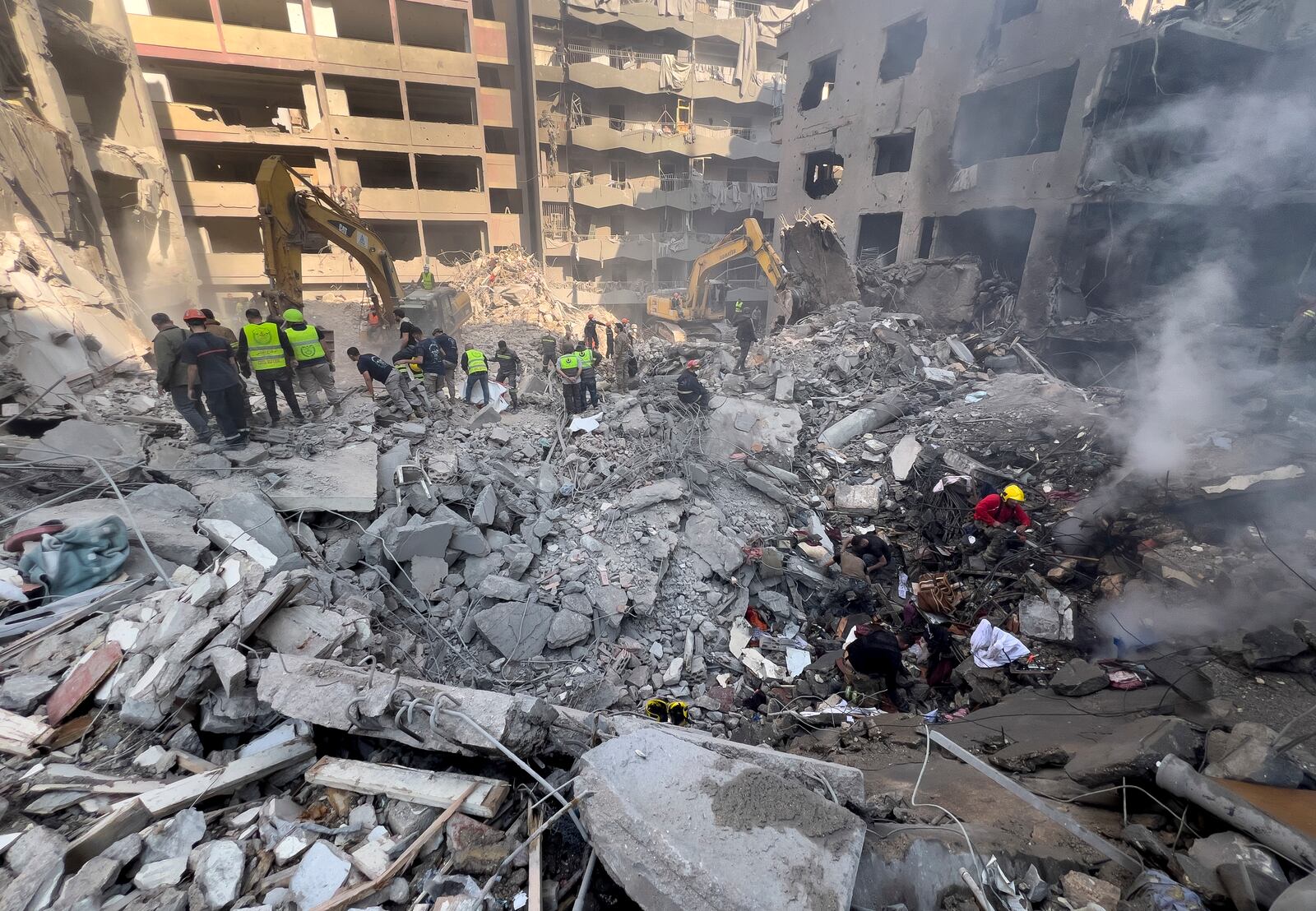 Rescue workers search for victims at the site of an Israeli airstrike that hit central Beirut, Lebanon, Saturday, Nov. 23, 2024. (AP Photo/Hussein Malla)