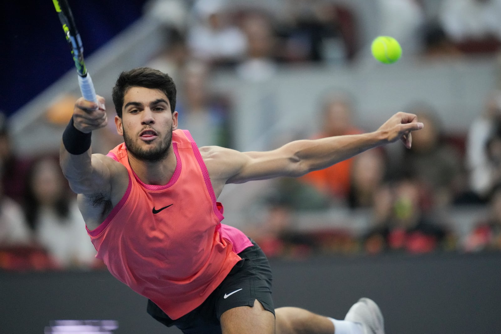 FILE - Carlos Alcaraz of Spain returns a shot from Jannik Sinner of Italy during their men's singles finals match of the China Open tennis tournament, at the National Tennis Center in Beijing, Wednesday, Oct. 2, 2024. (AP Photo/Achmad Ibrahim, File)