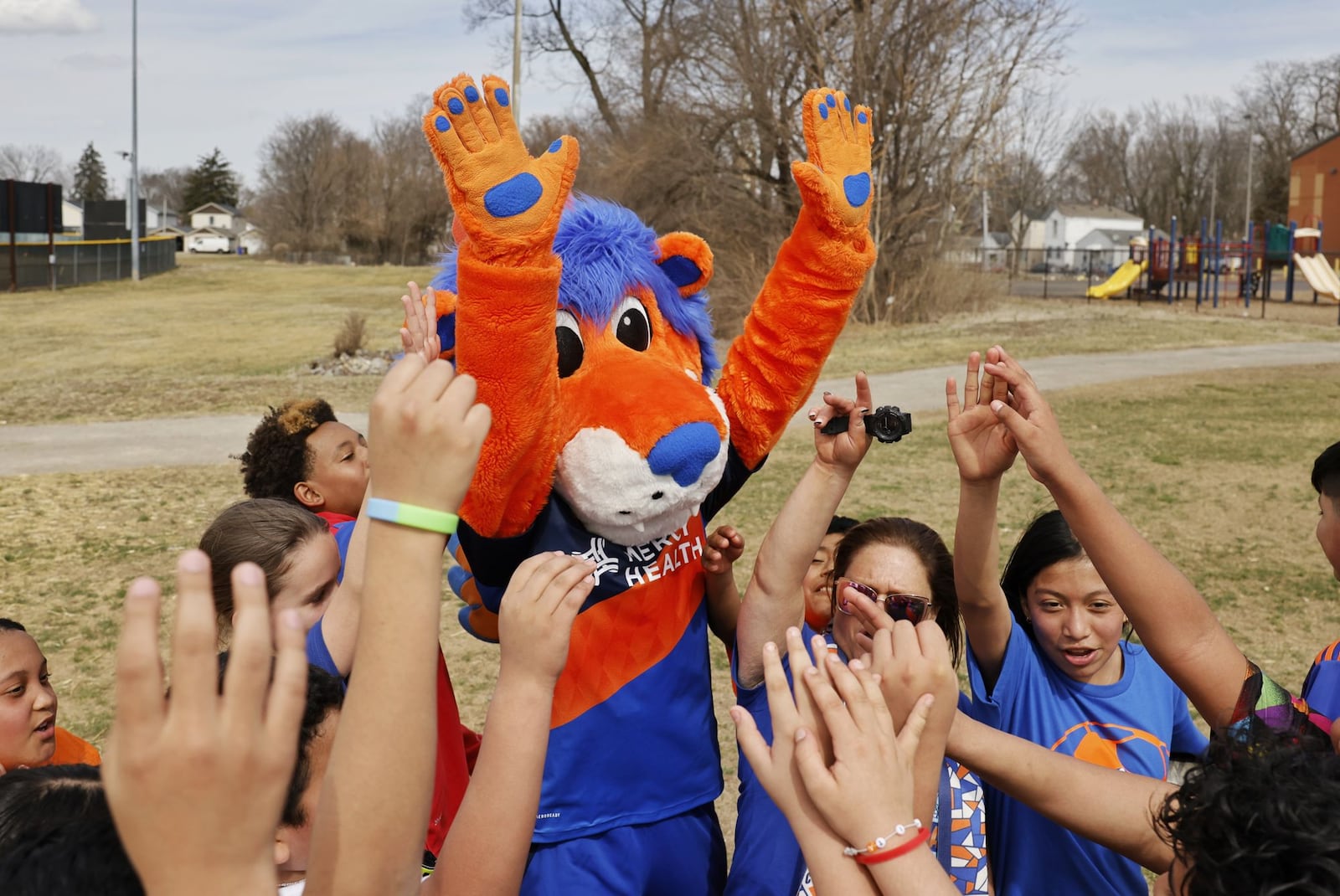 FC Cincinnati mascot Gary the Lion meets with kids during the grand opening of the 11th FC Mini Pitch Friday, March 14, 2025, at the Booker T. Washington Center, 1140 S. Front St. in Hamilton. NICK GRAHAM/STAFF