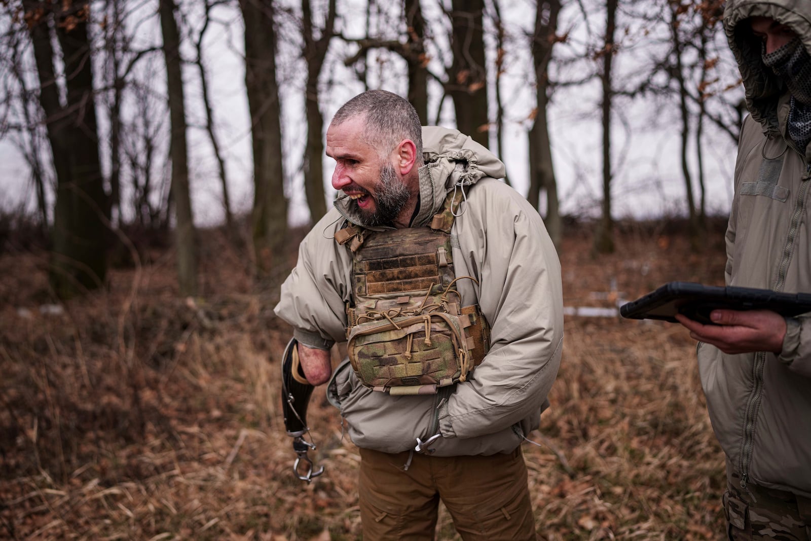 Andrii Rubliuk, a senior sergeant with a Ukrainian intelligence unit who lost both arms and a leg in combat, smiles during a training exercise near Kyiv, Ukraine, on Feb. 14, 2025. (AP Photo/Evgeniy Maloletka)