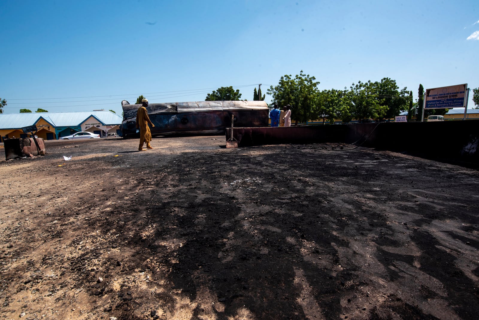 People gather at the scene of a fuel tanker explosion in Majiya town, Nigeria, Wednesday, Oct. 16, 2024. (AP Photo/Sani Maikatanga)