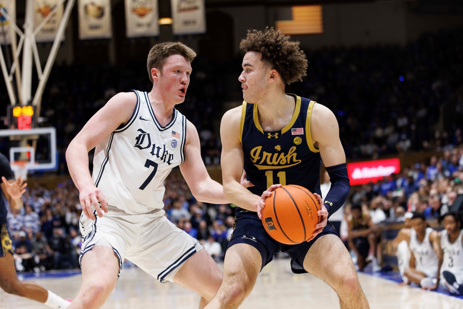 Notre Dame's Braeden Shrewsberry (11) handles the ball as Duke's Kon Knueppel (7) defends during the first half of an NCAA college basketball game in Durham, N.C., Saturday, Jan. 11, 2025. (AP Photo/Ben McKeown)