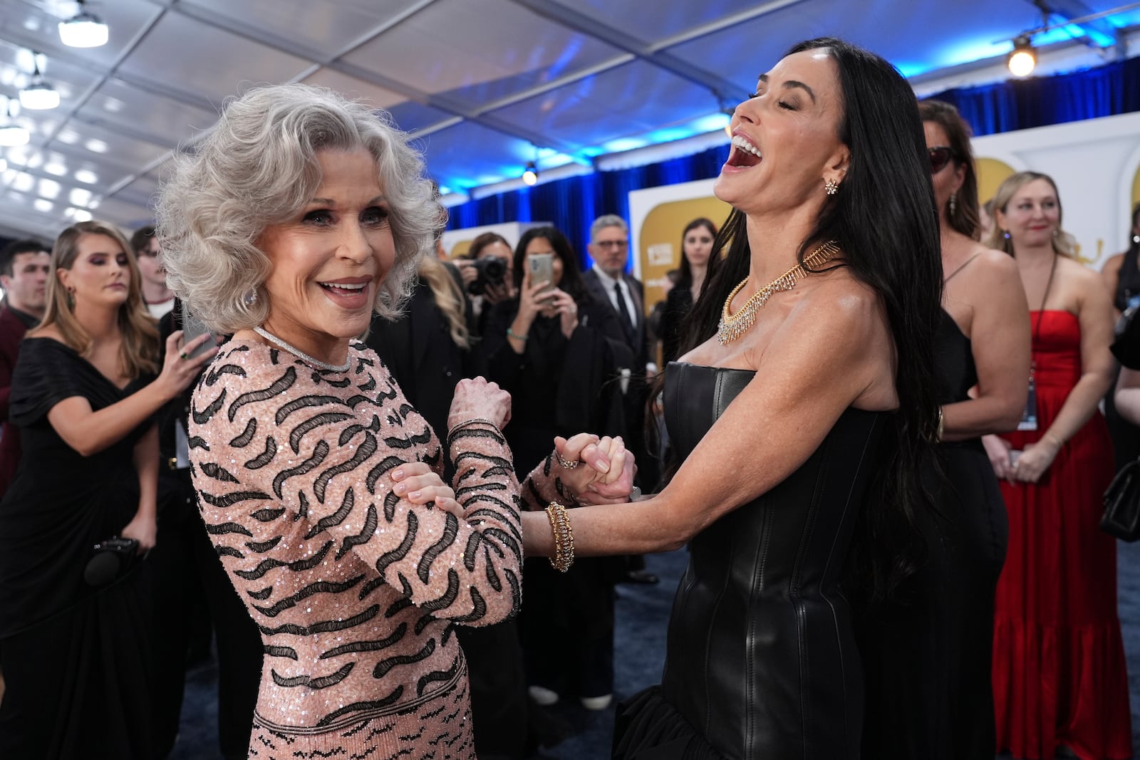 Jane Fonda, left, and Demi Moore arrive at the 31st annual Screen Actors Guild Awards on Sunday, Feb. 23, 2025, at the Shrine Auditorium in Los Angeles. (AP Photo/Chris Pizzello)