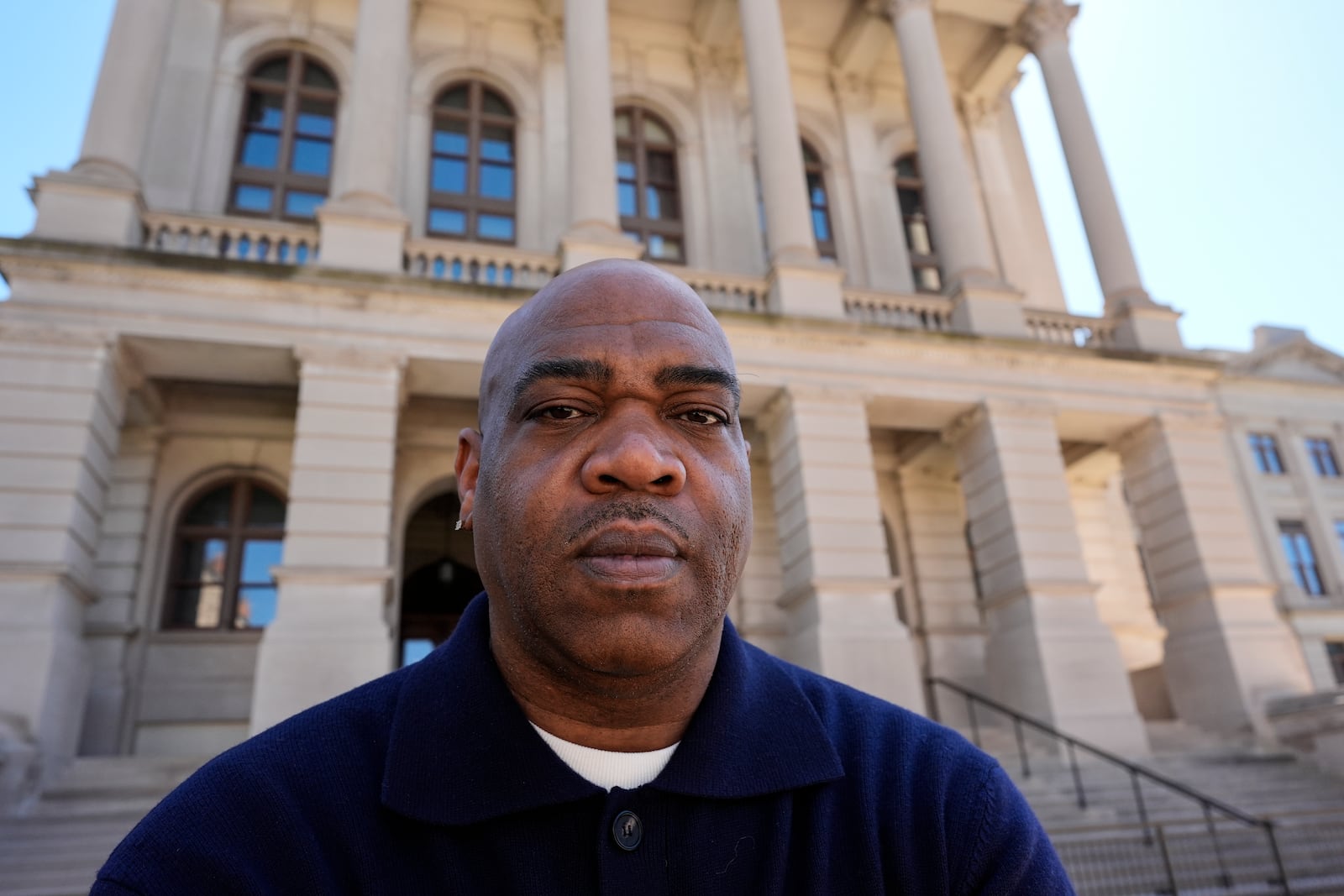 *Michael Woolfolk poses for a photo at the state capitol, Thursday, March 6, 2025, in Atlanta. (AP Photo/Mike Stewart)