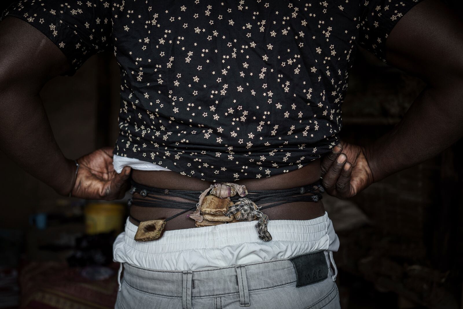 Ibrahim, a fervent believer of Senegalese mysticism, shows off his gris-gris in Tambacounda, Senegal on Thursday, Jan. 16, 2025. His gris-gris are made from animal skins, including lion, which is believed to offer protection and power. (AP Photo/Annika Hammerschlag)