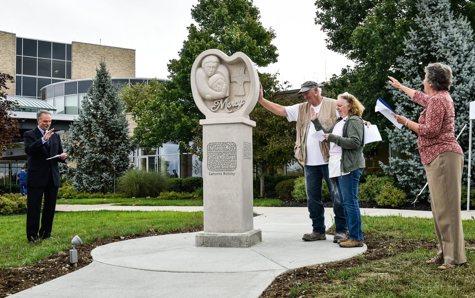 Left to right, Mercy Fairfield CEO Tom Urban, sculptor Al Nelson with his wife Penny Nelson and Sister Sharon Wiedmar recite a prayer to dedicate a newly erected statue commemorating forty years of operation for the hospital during a ceremony Wednesday, Sept. 26 in Fairfield. 