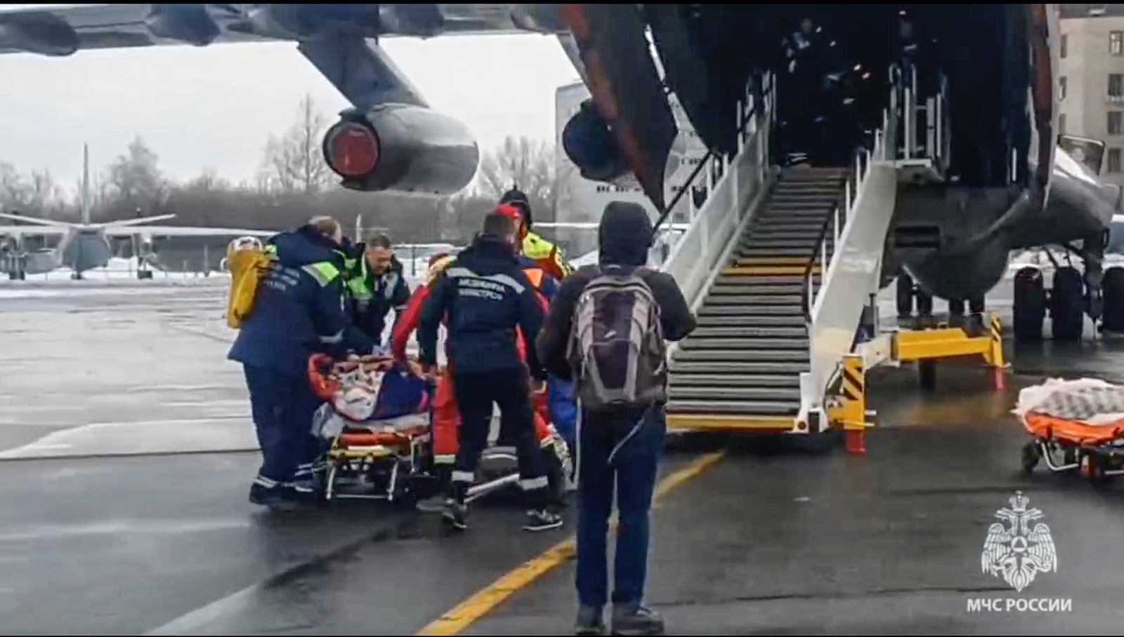 In this image taken from video released by the Russian Emergency Ministry Press Service, rescuers transport wounded passengers from a medical plane after the Azerbaijani Airline crashed, near the Kazakhstani city of Aktau, upon their arrival at the Zhukovsky airport outside Moscow, Russia, on Thursday, Dec. 26, 2024. (Russian Emergency Ministry Press Service via AP)