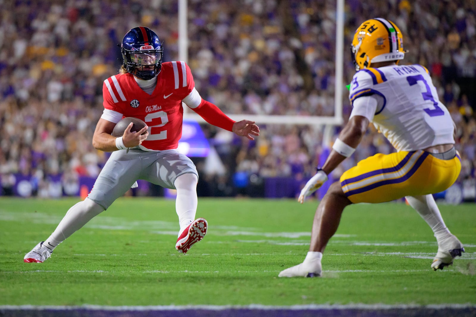 Mississippi quarterback Jaxson Dart (2) runs against LSU safety Sage Ryan (3) during the first half of an NCAA college football game in Baton Rouge, La., Saturday, Oct. 12, 2024. (AP Photo/Matthew Hinton)