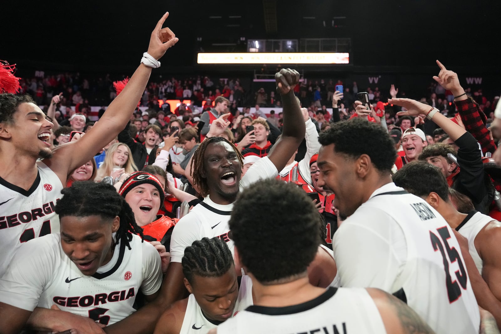 The Georgia basketball team celebrates with the University of Georgia students after a win against Kentucky at an NCAA college basketball game, Tuesday, Jan. 7, 2025, in Athens, Ga. (AP Photo/Brynn Anderson)