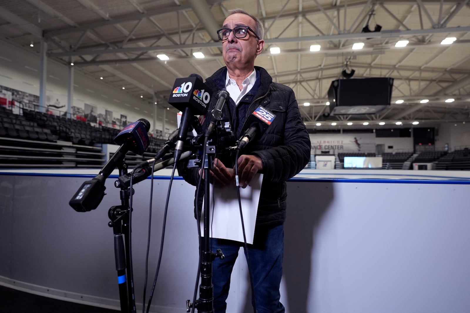 Doug Zeghibe, CEO and Executive Director of The Skating Club of Boston, pauses while announcing that six athletes, coaches and family are believed to have perished in the collision of a passenger aircraft and military helicopter in Washington, at the club's figure skating rink, Thursday, Jan. 30, 2025, in Norwood, Mass. (AP Photo/Charles Krupa)