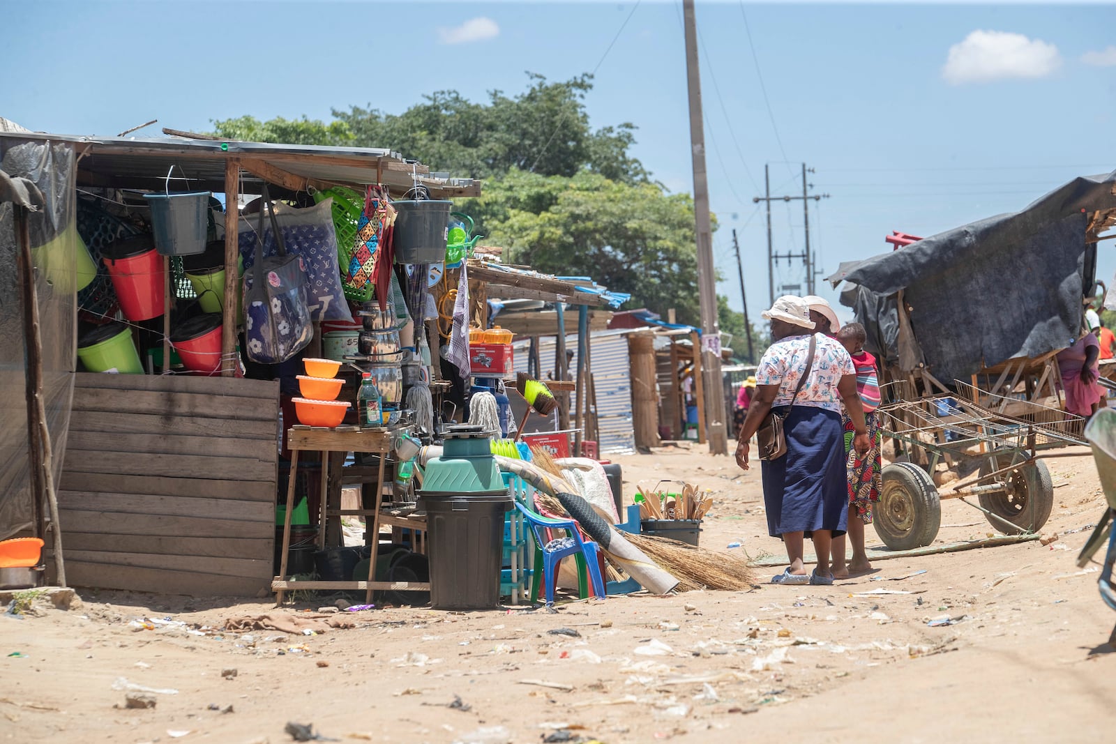 Women walk in a market in Harare, Zimbabwe, Friday, Feb. 7, 2025. (AP Photo/Aaron Ufumeli)