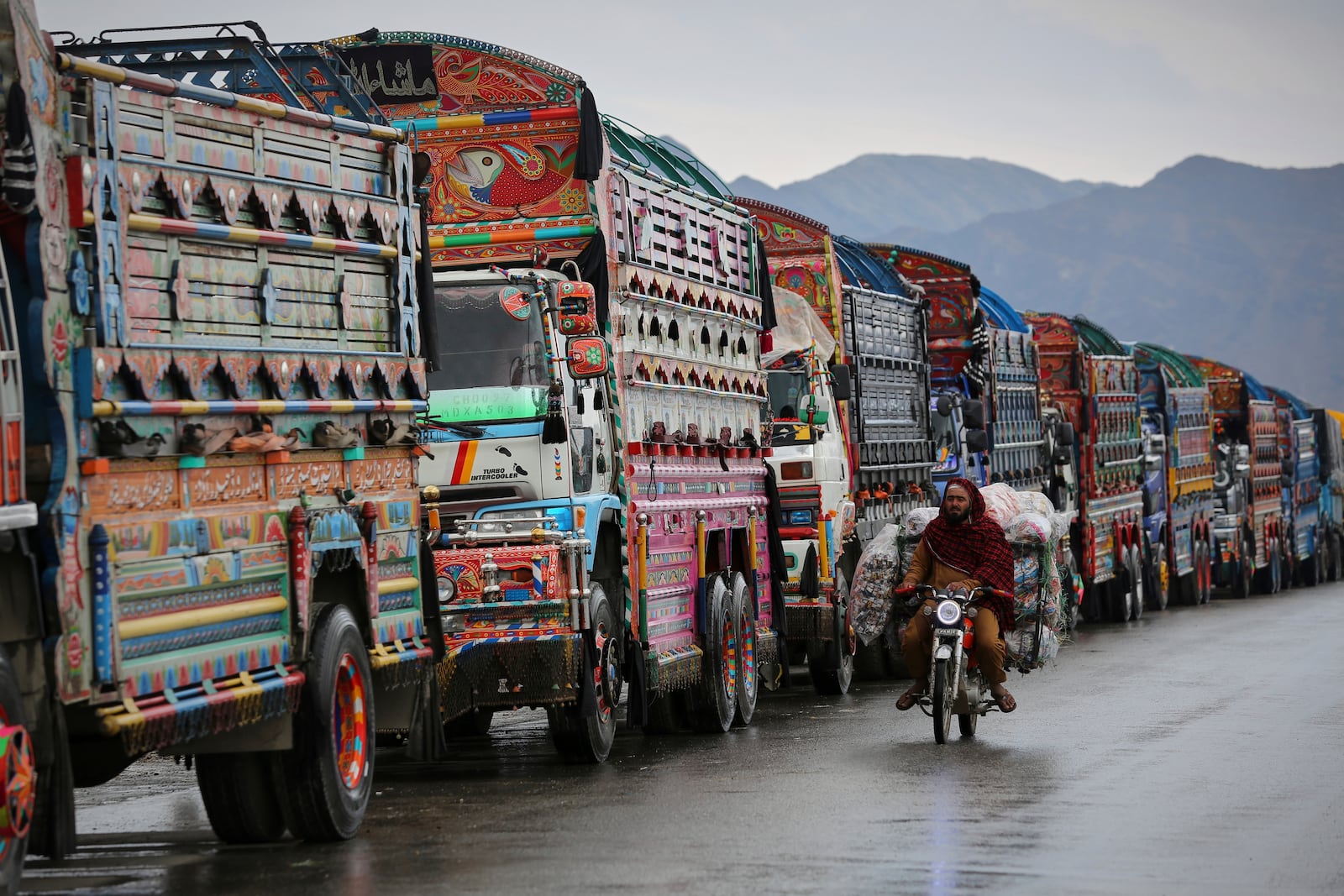 Trucks wait to cross the closed Torkham border with Pakistan, where Pakistani and Afghan forces exchanged fire overnight, in Torkham, Afghanistan, Monday, March 3, 2025.(AP Photo/Shafiullah Kakar)