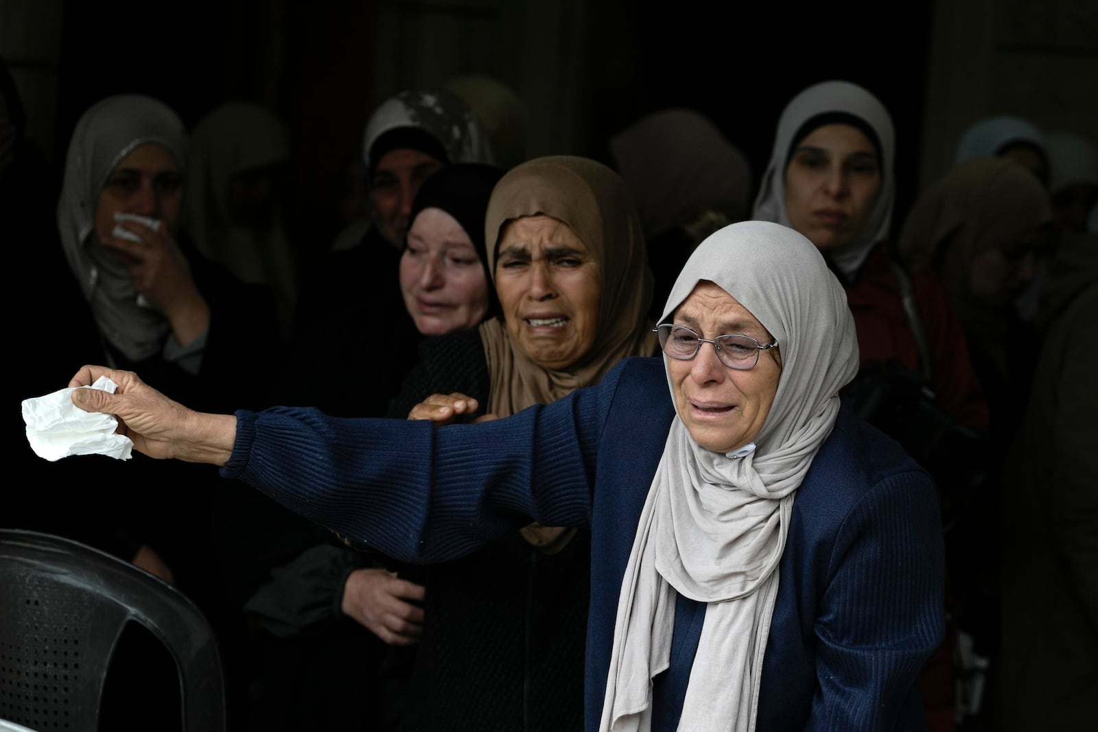 Mourners cry as they attend the funeral of Ahmad Nimer Al-Shaib after he was killed during an Israeli military operation in Jenin, in the West Bank village of Bruqin, Wednesday, Jan. 22, 2025. (AP Photo/Majdi Mohammed)