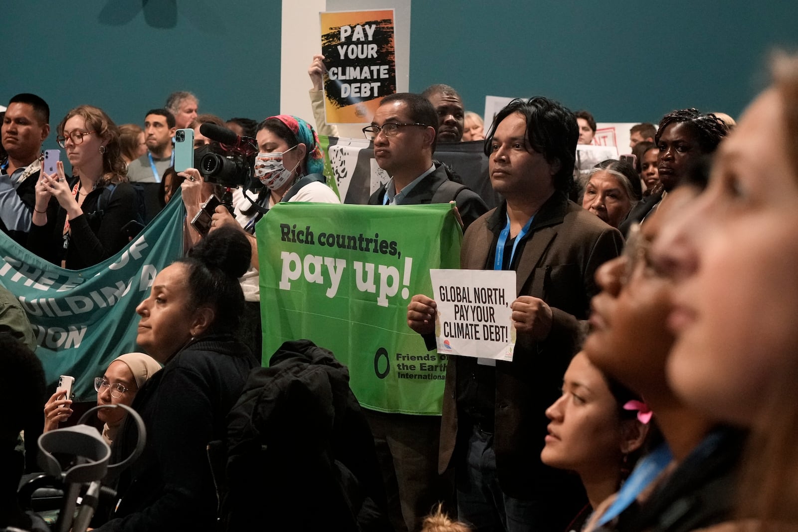 Activists participate in a demonstration for climate finance at the COP29 U.N. Climate Summit, Saturday, Nov. 16, 2024, in Baku, Azerbaijan. (AP Photo/Rafiq Maqbool)