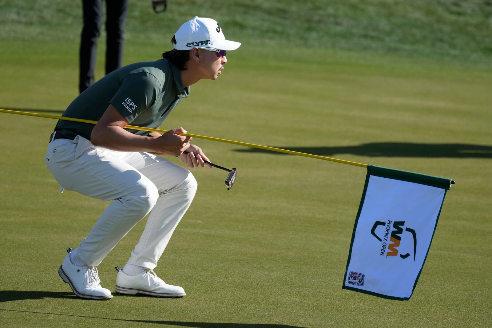 Min Woo Lee, of Australia, lines up a putt on the first hole during the third round of the Phoenix Open golf tournament at TPC Scottsdale Saturday, Feb. 8, 2025, in Scottsdale, Ariz. (AP Photo/Ross D. Franklin)