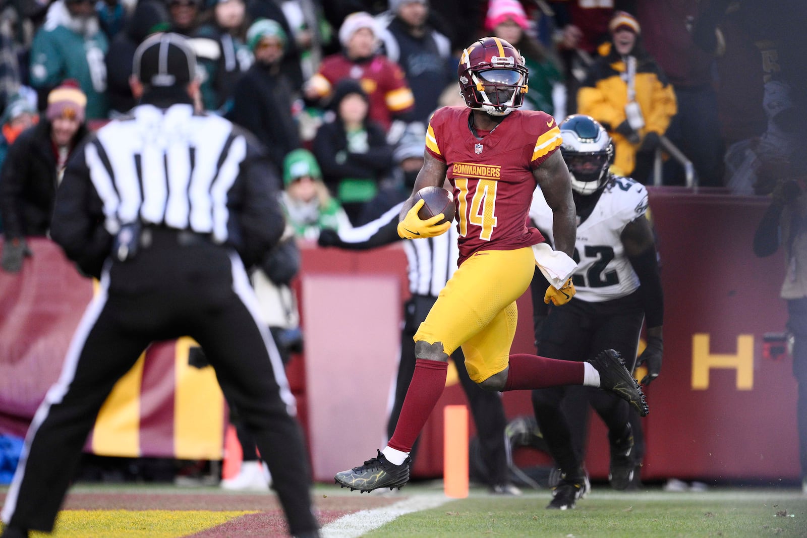 Washington Commanders wide receiver Olamide Zaccheaus (14) scores a touchdown against the Philadelphia Eagles during the second half of an NFL football game, Sunday, Dec. 22, 2024, in Landover, Md. (AP Photo/Nick Wass)