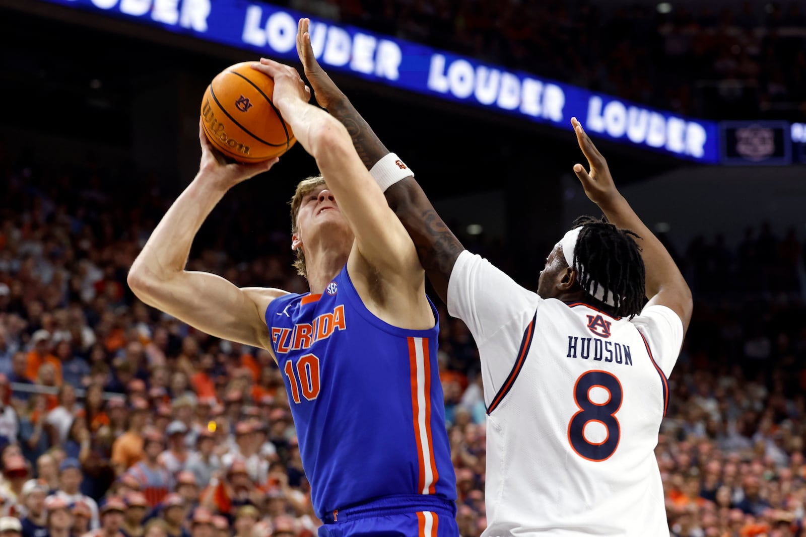 Florida forward Thomas Haugh (10) is fouled by Auburn forward Ja'Heim Hudson (8) as he shoots during the first half of an NCAA college basketball game, Saturday, Feb. 8, 2025, in Auburn, Ala. (AP Photo/Butch Dill)