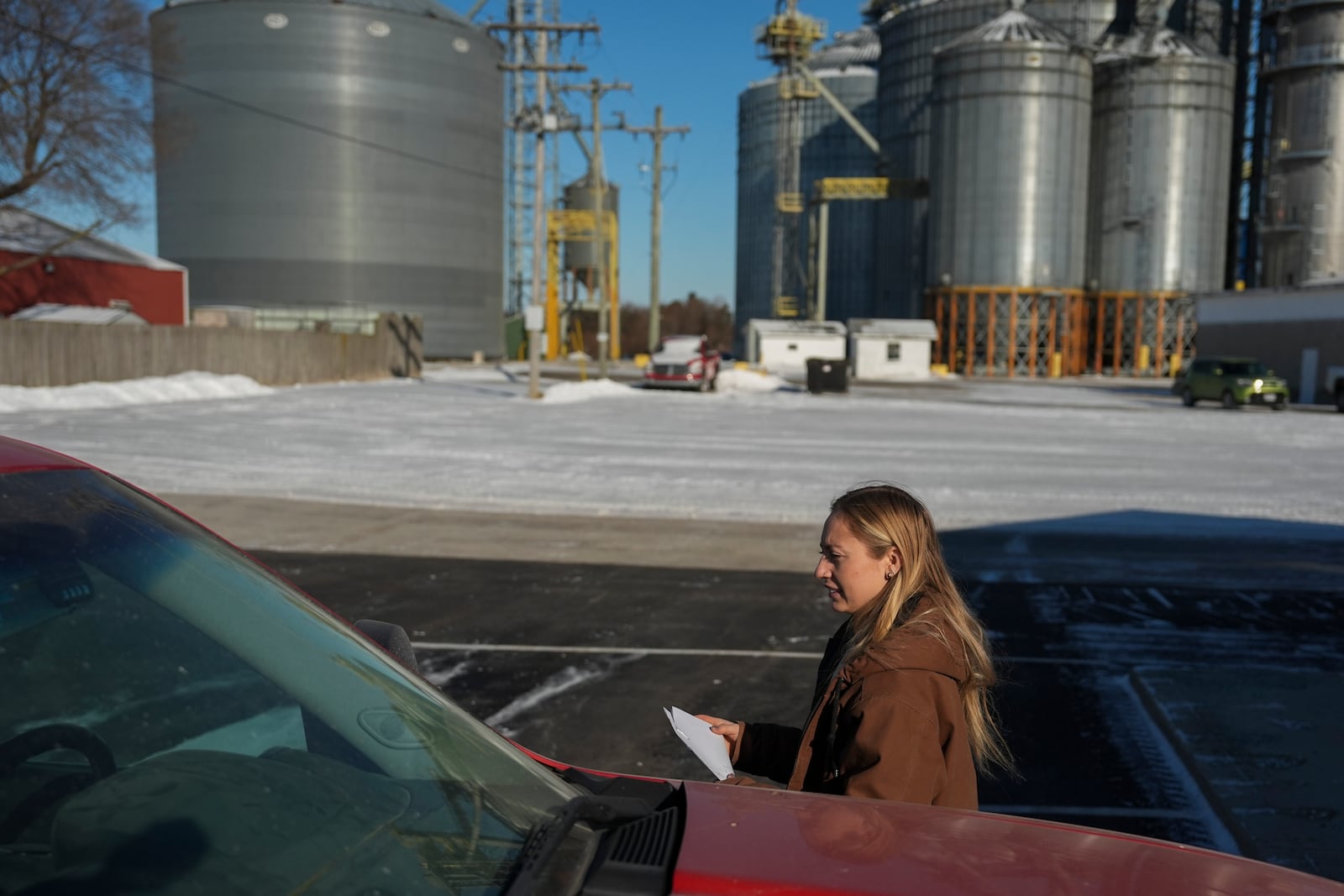 Zoe Kent walks back to her truck after running an errand at a local grain elevator, Monday, Jan. 20, 2025, in Upper Sandusky, Ohio. (AP Photo/Joshua A. Bickel)