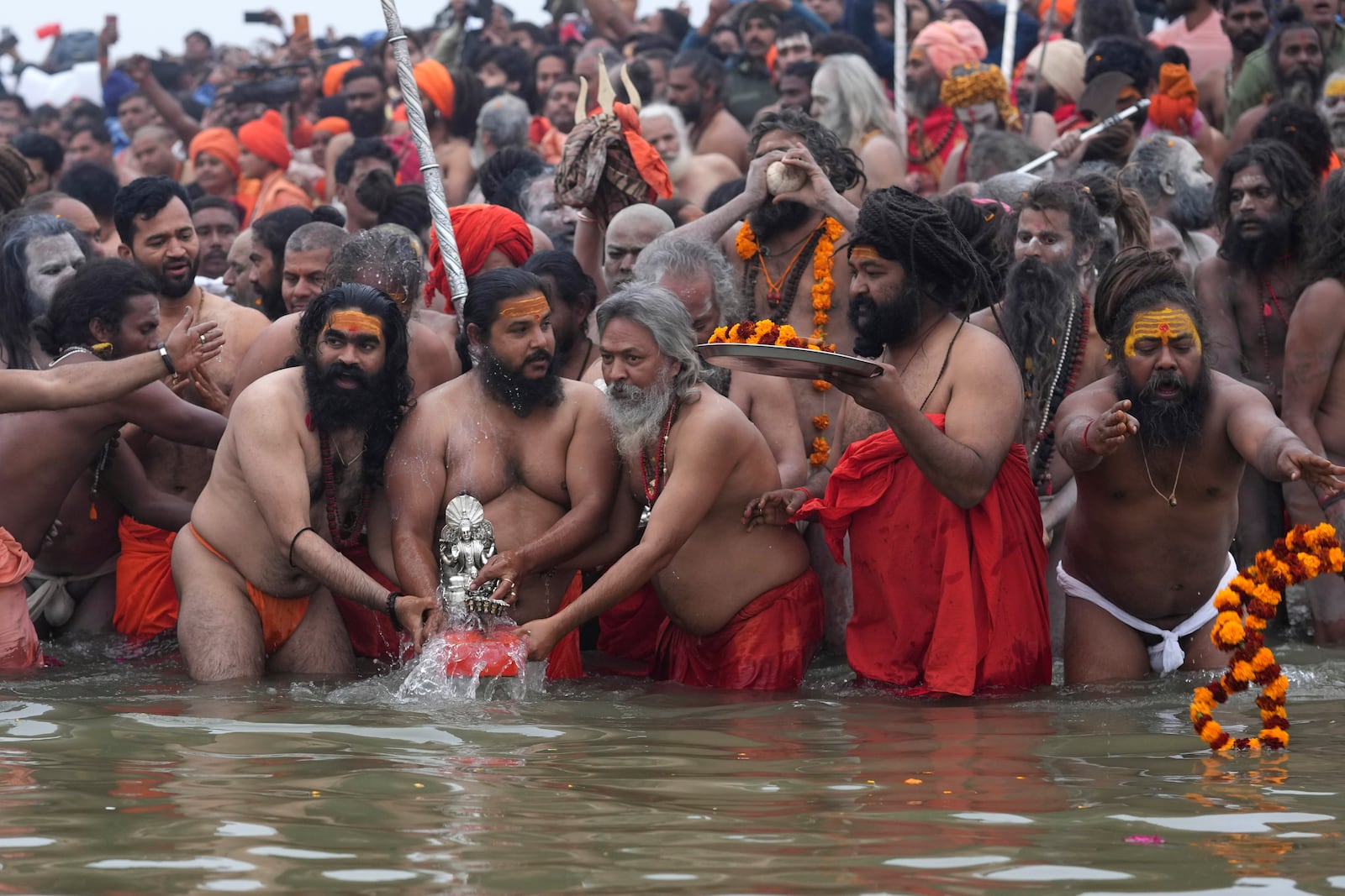 Naga Sadhus of Juna Akhara perform rituals at Sangam, the confluence of the Rivers Ganges, Yamuna and mythical Saraswati on one of the most auspicious day Makar Sankranti, for the Maha Kumbh festival in Prayagraj, India, Tuesday, Jan. 14, 2025. (AP Photo/Rajesh Kumar Singh)