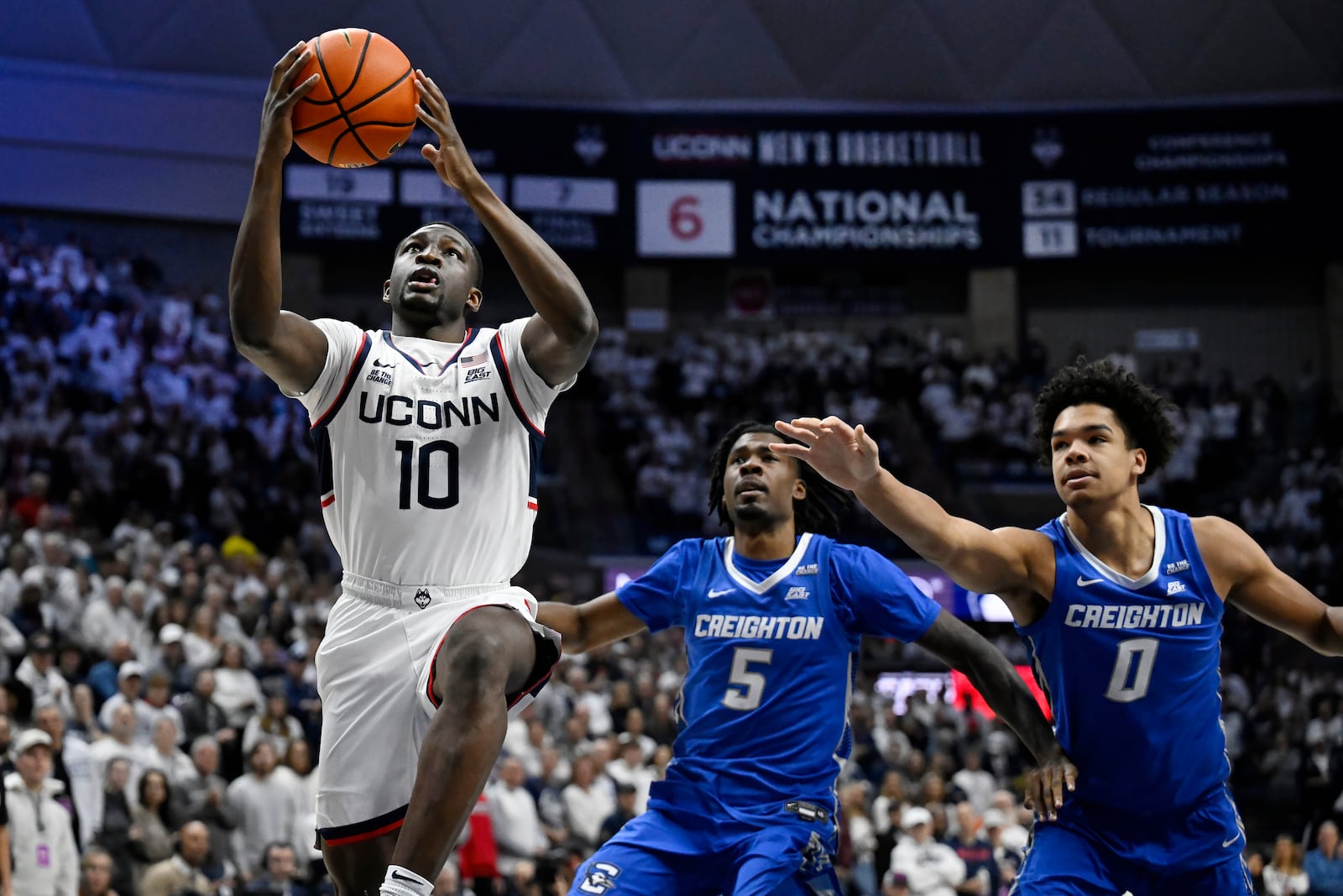 UConn guard Hassan Diarra (10) goes up to the basket past Creighton guard Jamiya Neal (5) and forward Jasen Green (0) in the first half of an NCAA college basketball game, Saturday, Jan. 18, 2025, in Storrs, Conn. (AP Photo/Jessica Hill)