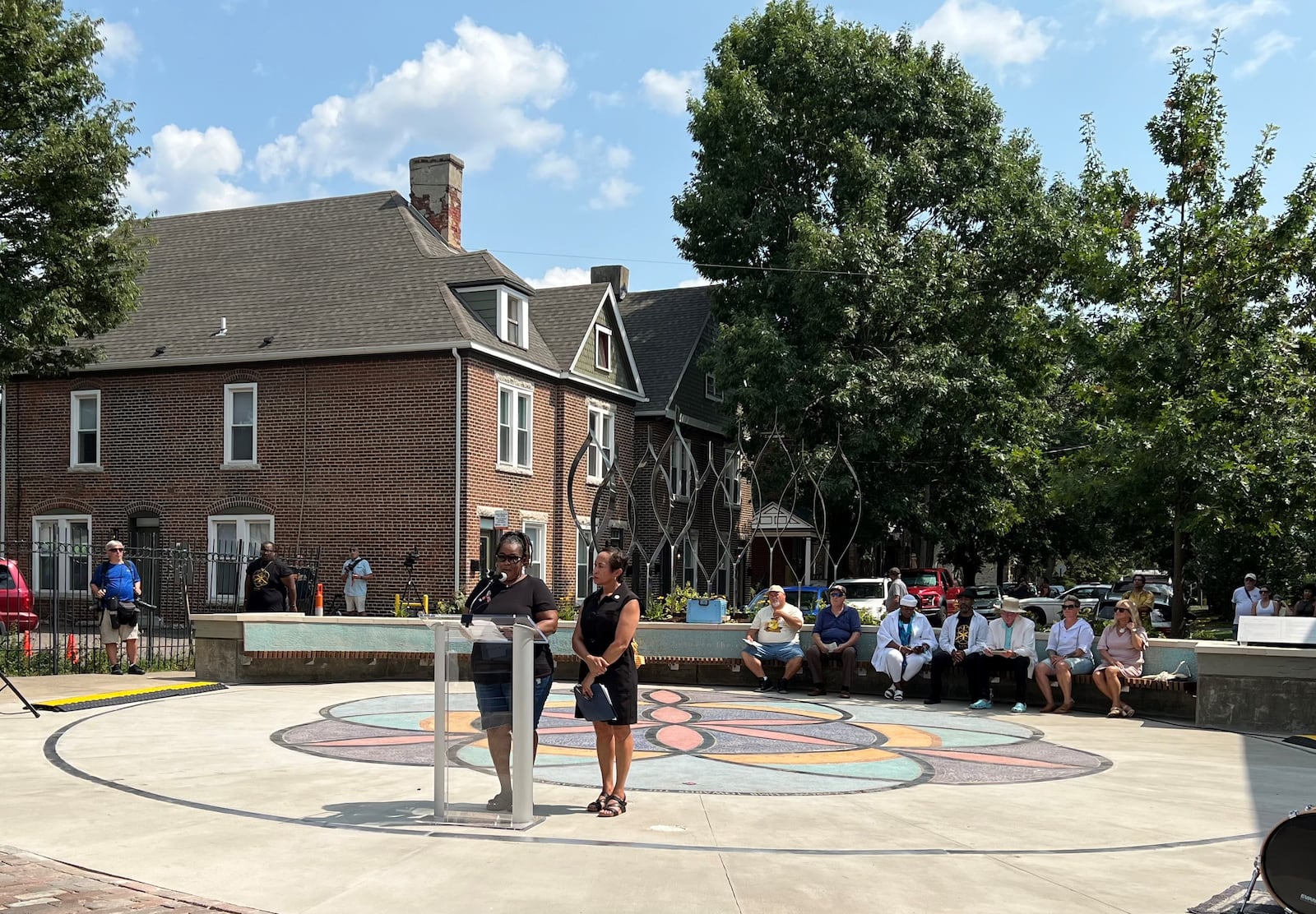 LaSandra James (left) and Sandy Hunt (right) spoke at the unveiling of the Seed of Life memorial to the victims of the 2019 Oregon District shooting. The event was Sunday, Aug. 4, 2024. James' daughter, Lois Oglesby, was one of nine people killed 5 years ago. LYNN HULSEY/STAFF