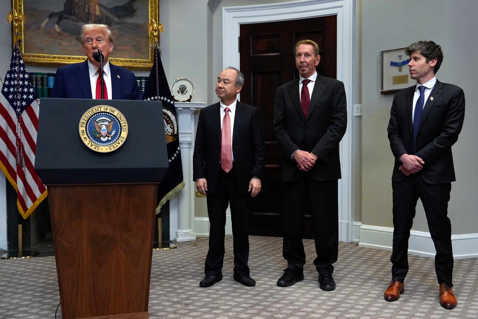 President Donald Trump, from left, speaks as Masayoshi Son, SoftBank Group CEO, Larry Ellison, chairman of Oracle Corporation and chief technology officer, and Sam Altman, OpenAI CEO listen in the Roosevelt Room at the White House, Tuesday, Jan. 21, 2025, in Washington. (AP Photo/Julia Demaree Nikhinson)