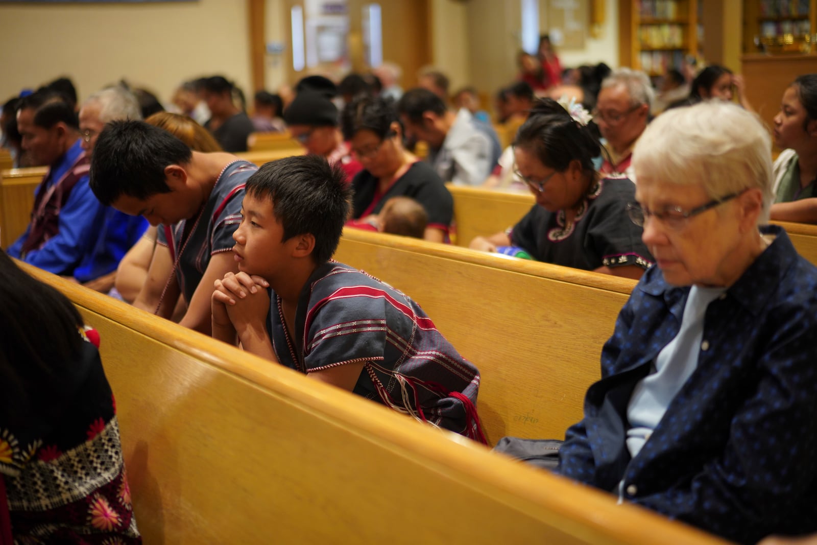 Parishioners pray during a Karen-language service at Indian Lake Baptist Church, while celebrating 15 years of partnership with the 150-year-old congregation founded by Swedish immigrants, in Worthington, Minn., on Sunday Oct. 20, 2024. (AP Photo/Jessie Wardarski)