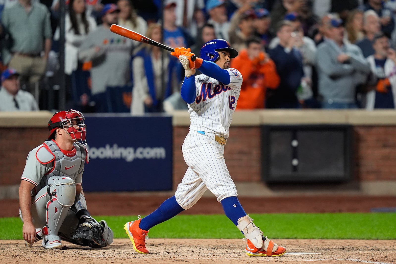 New York Mets' Francisco Lindor (12) follows through on a grand slam home run against the Philadelphia Phillies during the sixth inning of Game 4 of the National League baseball playoff series, Wednesday, Oct. 9, 2024, in New York. (AP Photo/Frank Franklin II)