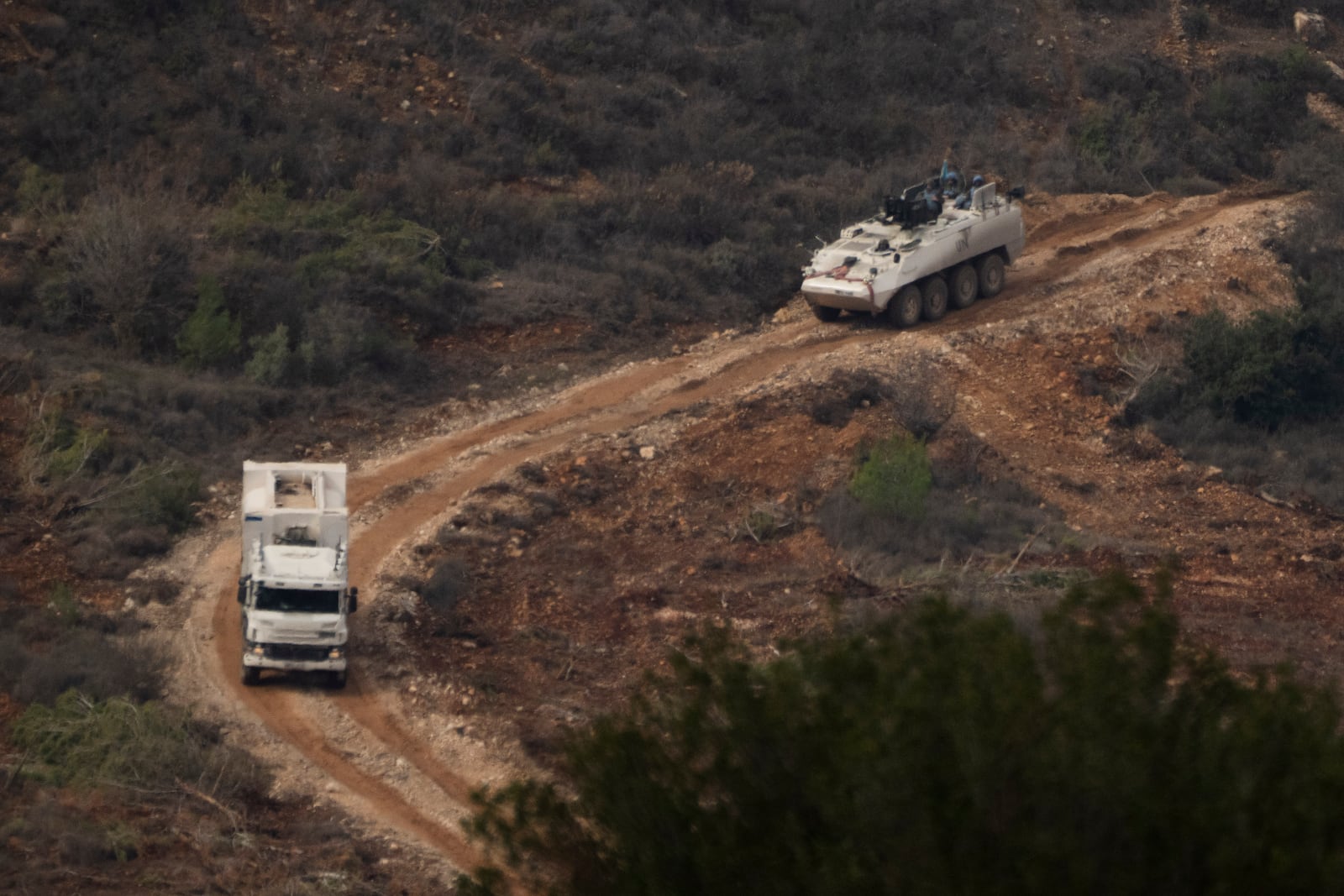 A convoy of the United Nations peacekeeping forces in Lebanon (UNIFIL) drives on area along the Israeli-Lebanese border as seen from northern Israel, Friday, Nov. 29, 2024. (AP Photo/Leo Correa)