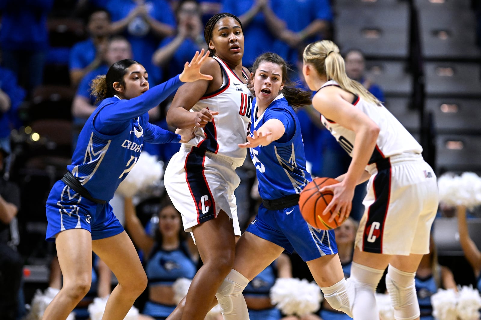 UConn guard Paige Bueckers, right, looks to pass the ball to UConn forward Sarah Strong, second from left, as Strong is pressured by Creighton guards Kiani Lockett, left, and Lauren Jensen, second from right, during the first half of an NCAA college basketball game in the finals of the Big East Conference tournament, Monday, March 10, 2025, in Uncasville, Conn. (AP Photo/Jessica Hill)