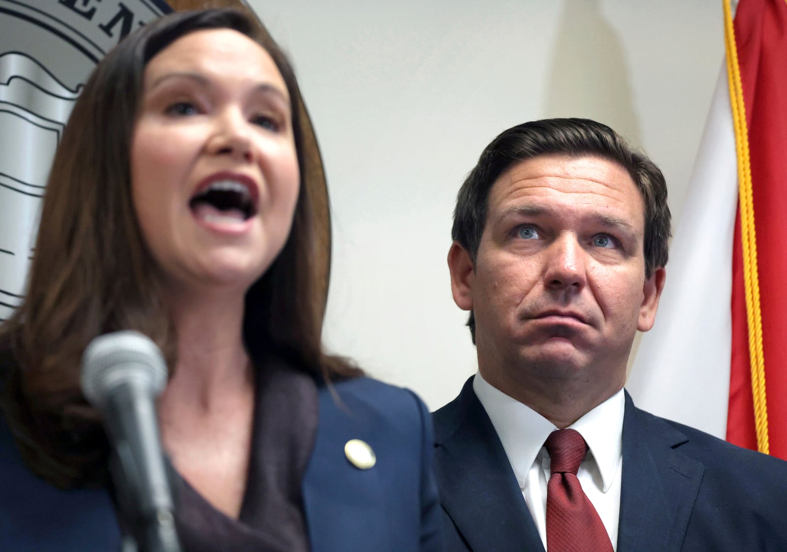 FILE - Florida Gov. Ron DeSantis listens to Florida Attorney General Ashley Moody during a news conference in Orlando, Fla., Aug. 26, 2021. (Joe Burbank/Orlando Sentinel via AP, file)