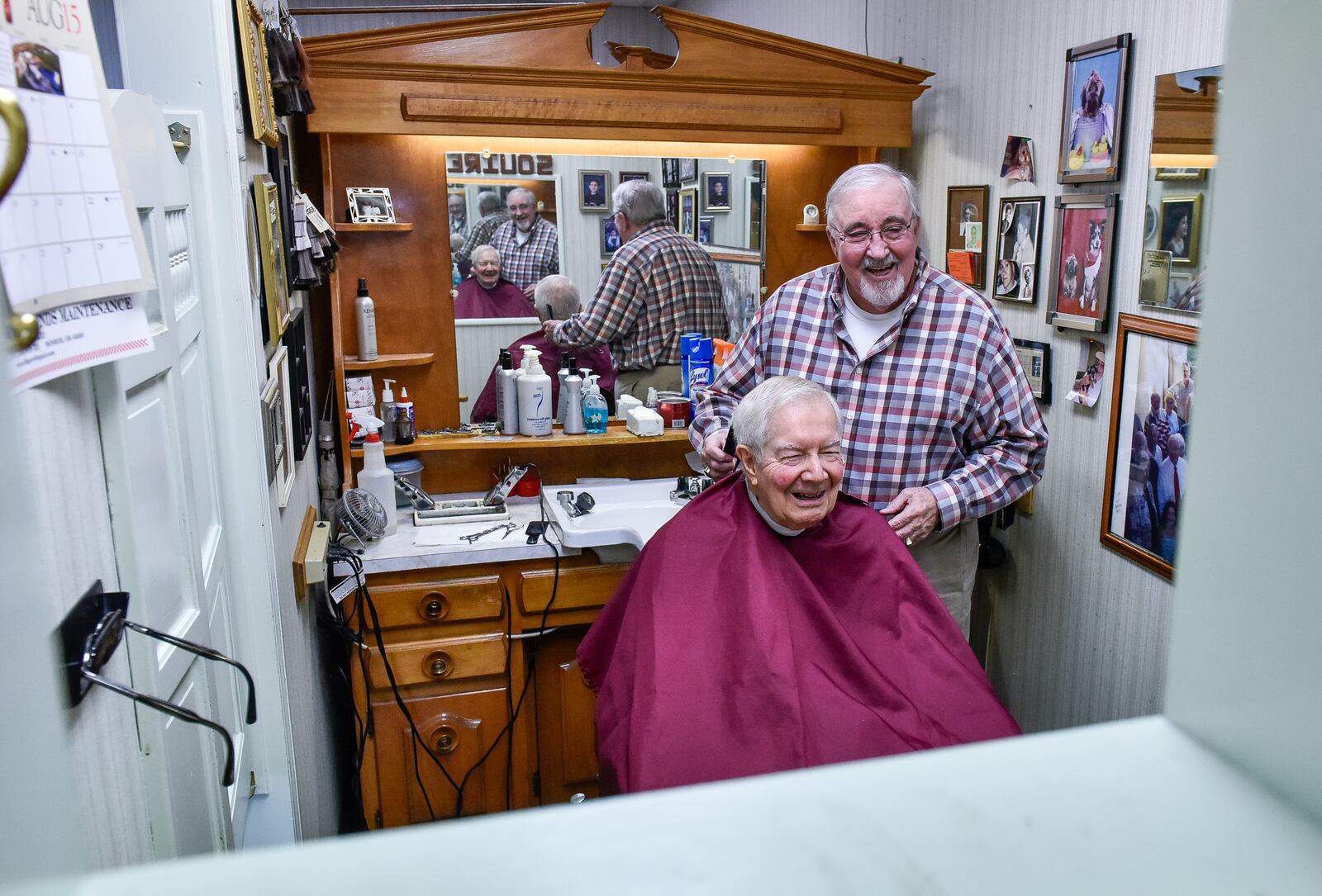 Bob Youtsler gives Bill Schaefer a haircut Wednesday, Jan. 10 at Squire Barber Service on Jackson Lane in Middletown. Youtsler, Pete Kurtz and Ishmael “Charlie” DeBord have worked together at Squire Barber Service for 50 years. NICK GRAHAM/STAFF