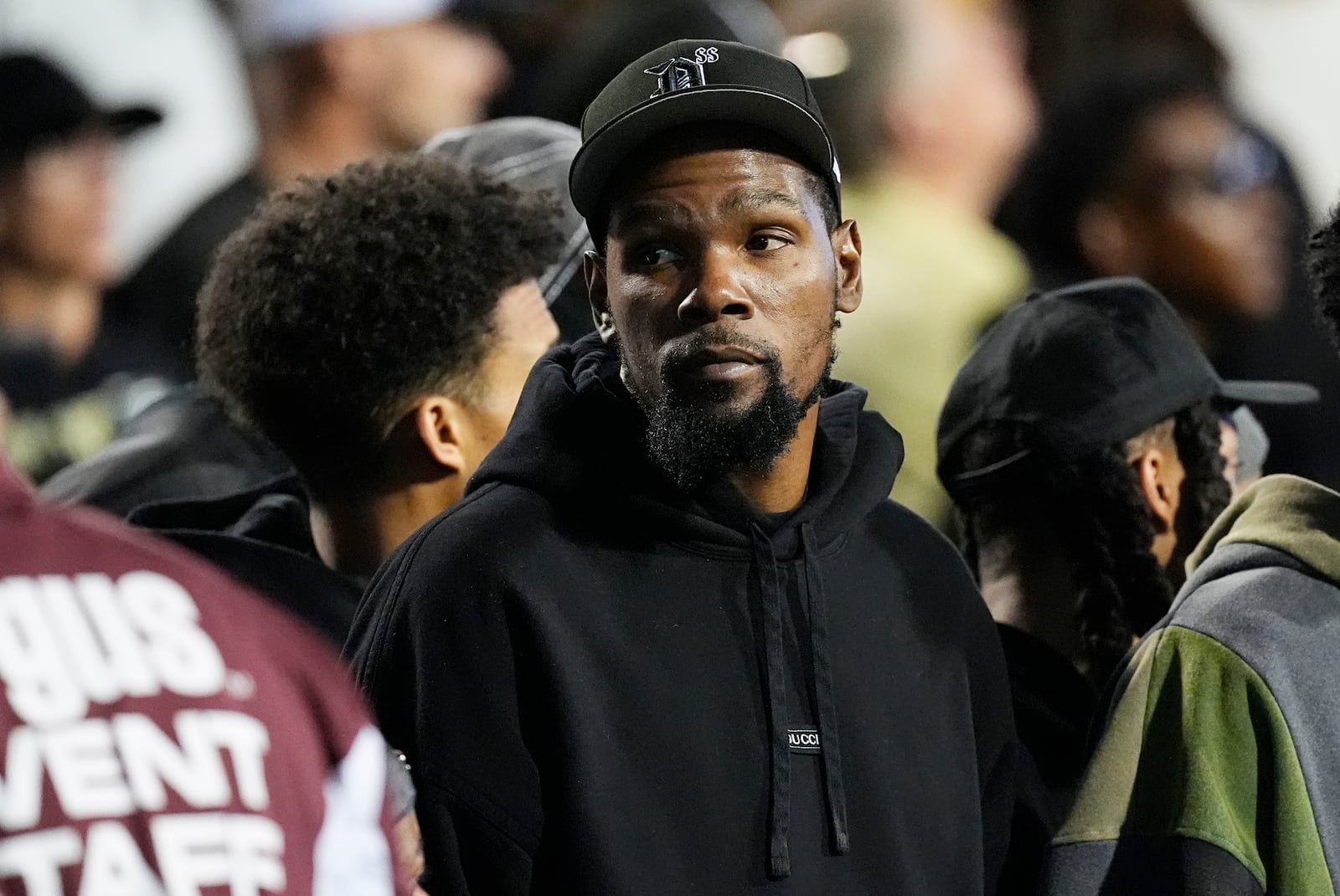 Phoenix Suns forward Kevin Durant joins teammates in watching Colorado host Kansas State in the first half of an NCAA college football game Saturday, Oct. 12, 2024, in Boulder, Colo. (AP Photo/David Zalubowski)