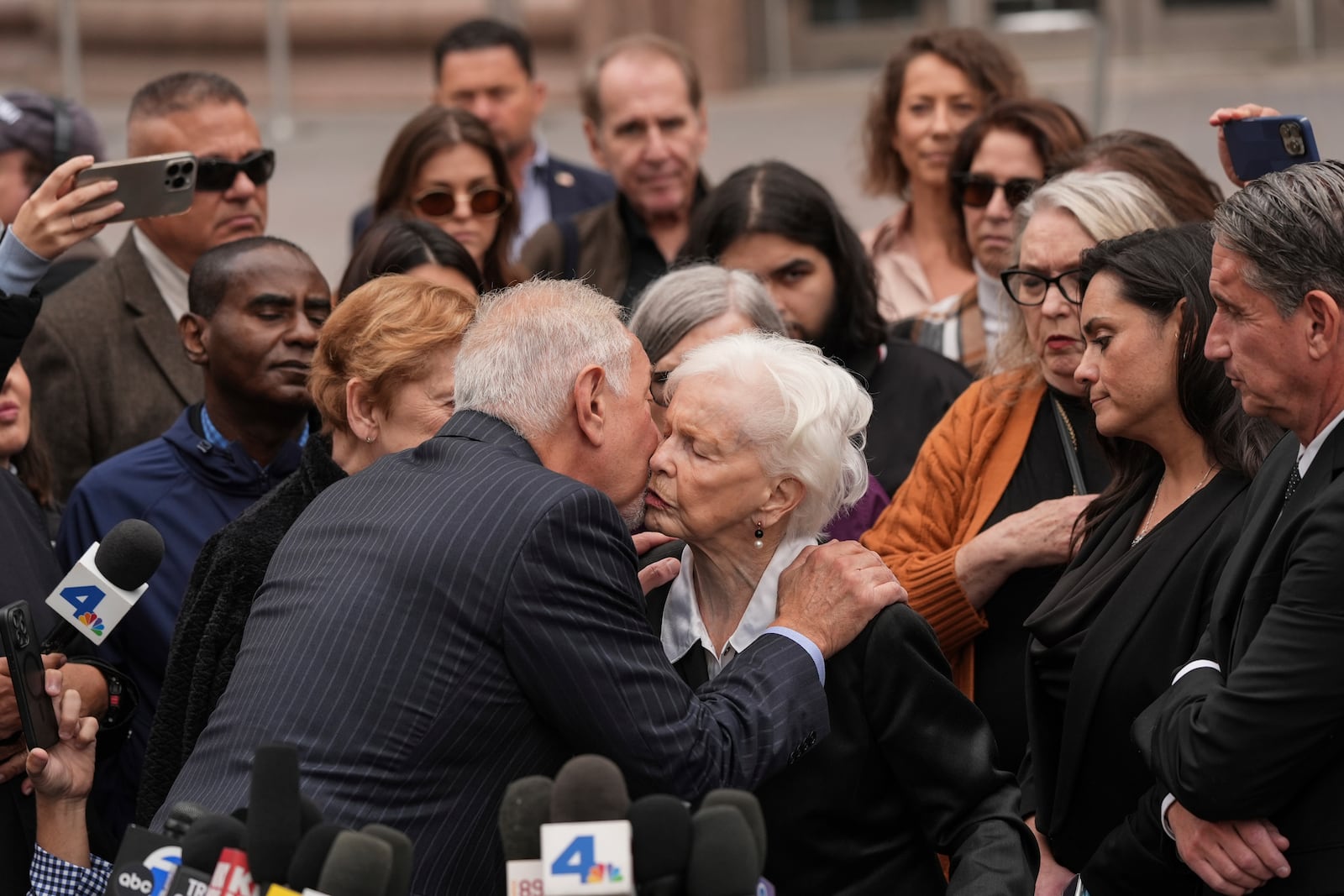 Erik and Lyle Menendez's aunt Joan VanderMolen, center right, is comforted by attorney Mark Geragos after a hearing in Los Angeles, Monday, Nov. 25, 2024. (AP Photo/Jae C. Hong)