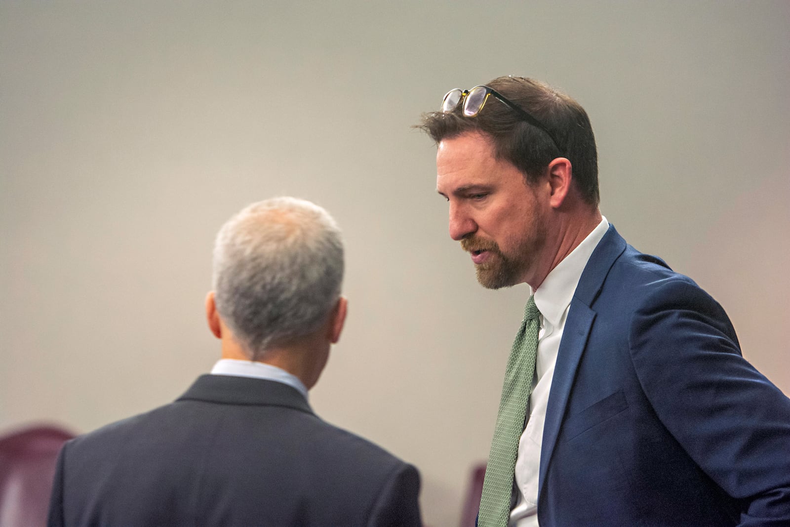 Prosecutor John Fowler, right, talks with defense attorney Brian Steel on Tuesday, Jan. 21, 2025, at the Glynn County courthouse in Brunswick, Ga., as jury selection begins in the trial of former District Attorney Jackie Johnson. She’s charged with interfering in the police investigation of the 2020 killing of Ahmaud Arbery. (Michael Hall/The Brunswick News via AP, Pool)