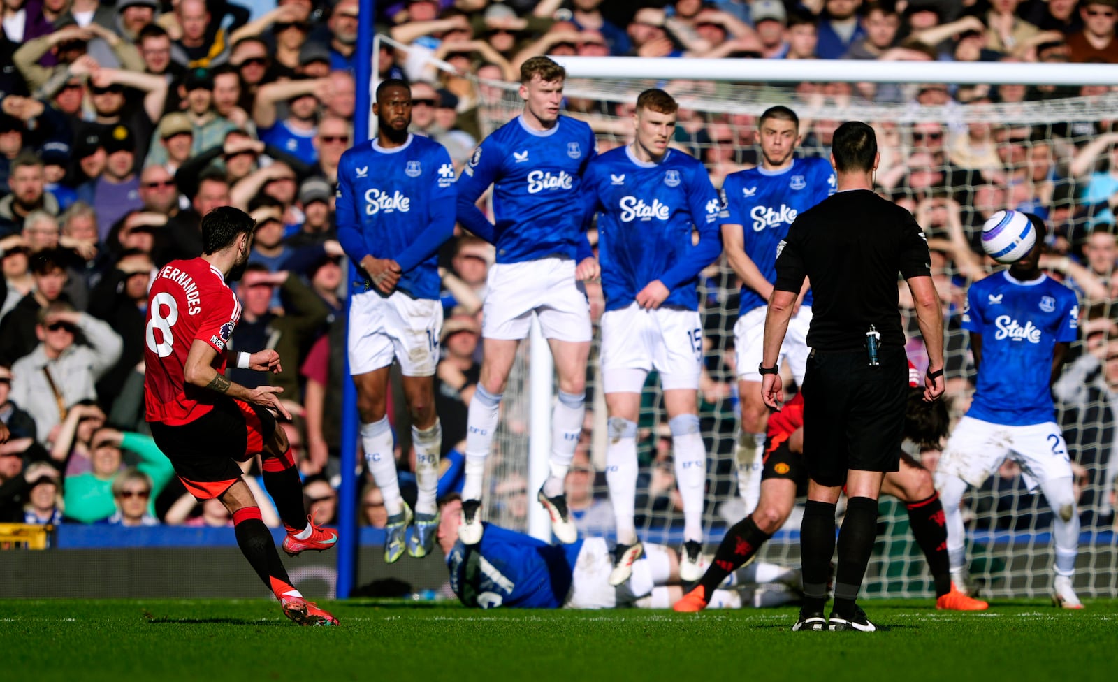 Manchester United's Bruno Fernandes score his sides first goal, during the English Premier League soccer match between Everton and Manchester United, at Goodison Park, in Liverpool, England, Saturday, Feb. 22, 2025. (Peter Byrne/PA via AP)