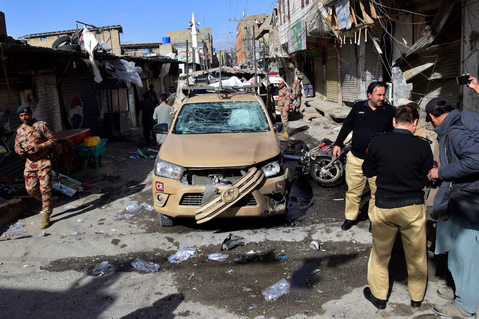 Security officials check a damaged security forces' vehicle at the site of a bomb blast in Quetta, Pakistan, Friday, Feb. 28, 2025. (AP Photo/Arshad Butt)