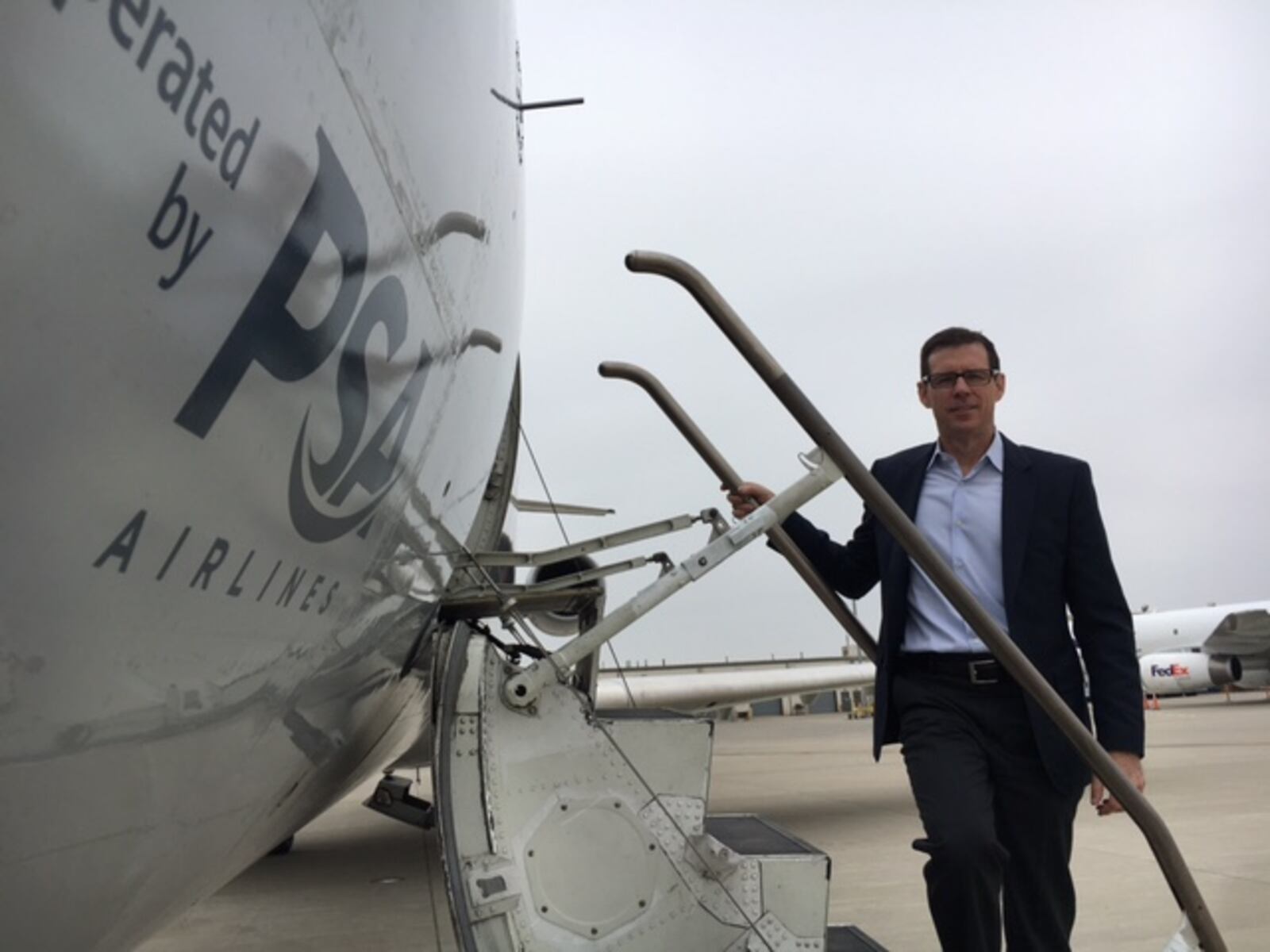 PSA Airlines President Dion Flannery, on the steps of a Bombardier CRJ aircraft.