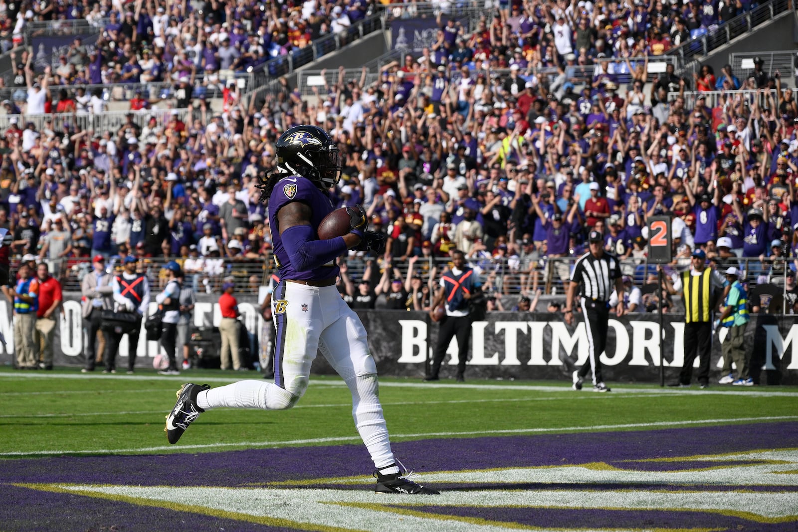 Baltimore Ravens running back Derrick Henry (22) scores on a 7-yard run during the second half of an NFL football game against the Washington Commanders Sunday, Oct. 13, 2024, in Baltimore. (AP Photo/Nick Wass)