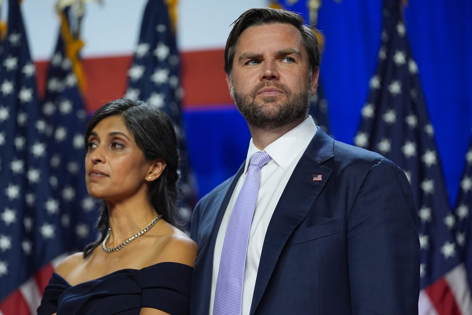 Republican vice presidential nominee Sen. JD Vance, R-Ohio, and his wife Usha Vance listen as Republican presidential nominee former President Donald Trump attends an election night watch party at the Palm Beach Convention Center, Wednesday, Nov. 6, 2024, in West Palm Beach, Fla. (AP Photo/Evan Vucci)