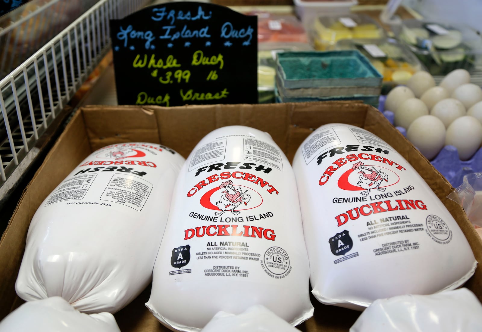 FILE - Whole ducklings, processed and packaged fresh that morning, sit in a cooler for sale at a retail store just over a mile away from their origin at Crescent Duck Farm, in Aquebogue, N.Y., Oct. 29, 2014. (AP Photo/Julie Jacobson, File)