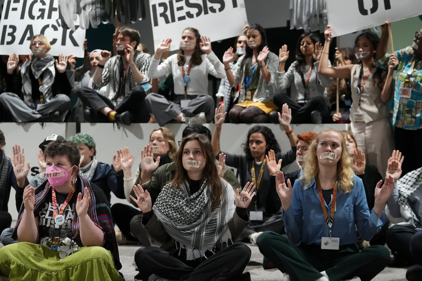 Activists participate in a demonstration at the COP29 U.N. Climate Summit, Saturday, Nov. 23, 2024, in Baku, Azerbaijan. (AP Photo/Sergei Grits)