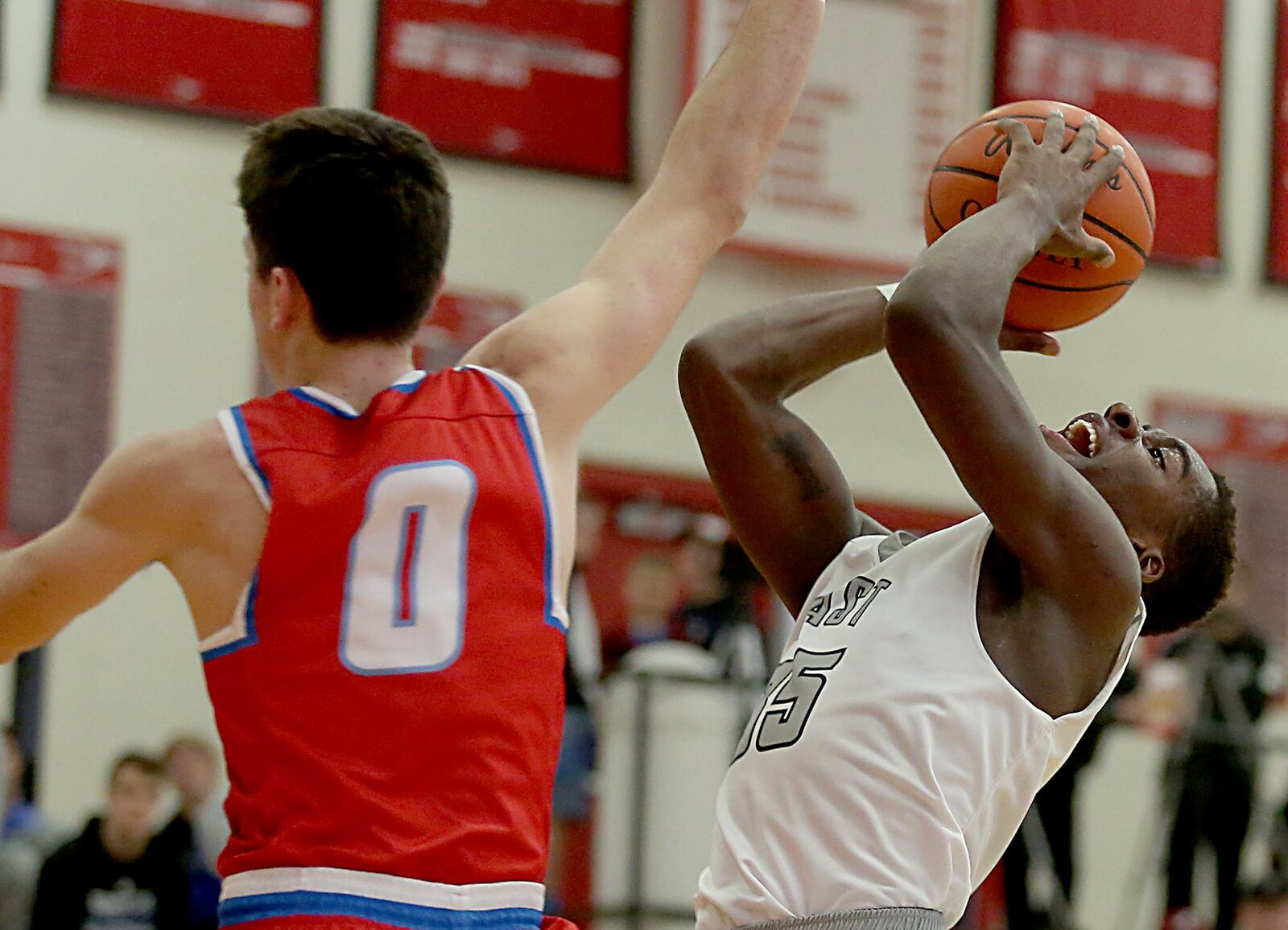 Lakota East guard Jarrett Cox shoots as Kings guard Gabe Stacy makes an attempt to block during Wednesday night’s Division I sectional contest at Lakota West. CONTRIBUTED PHOTO BY E.L. HUBBARD