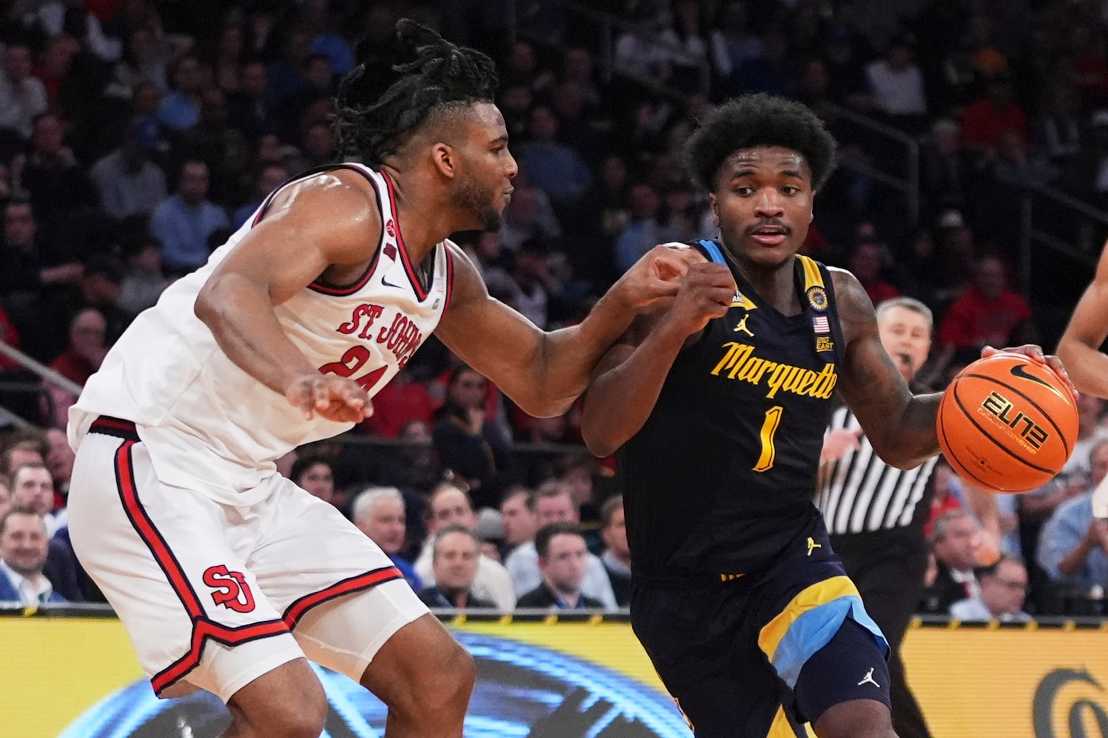 St. John's's Zuby Ejiofor (24) defends Marquette's Kam Jones (1) during the second half of an NCAA college basketball game in the semifinals of the Big East tournament Friday, March 14, 2025, in New York. (AP Photo/Frank Franklin II)