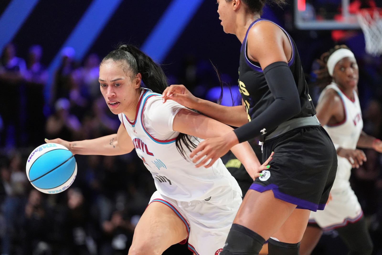 Vinyl forward Dearica Hamby, left, drives past Lunar Owls forward Napheesa Collier in their Unrivaled 3-on-3 basketball semifinal, Sunday, March 16, 2025, in Medley, Fla. (AP Photo/Rebecca Blackwell)