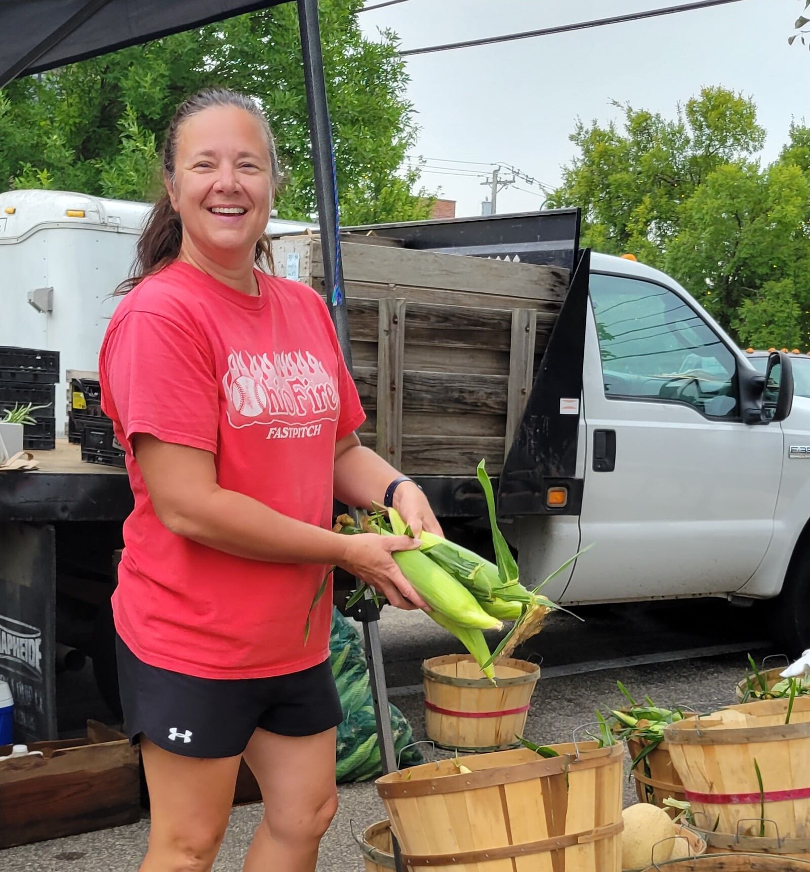 Rachel Downing, of Downing Fruit Farm, sells corn at the Oxford Farmers Market. CONTRIBUTED